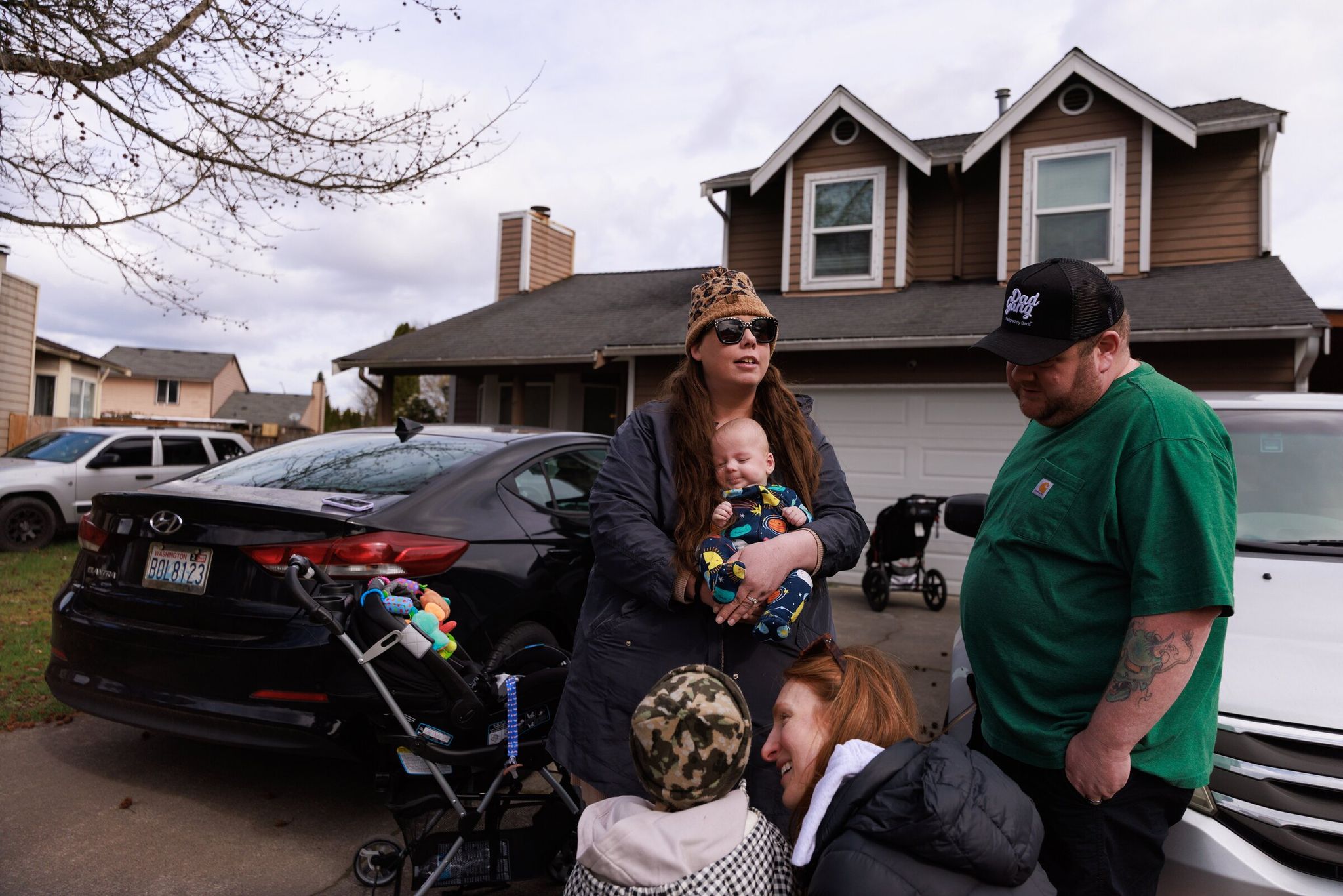 Jessica Adams and Kevin Week, standing, receive a visit from Adams’s best friend, Jessica Espinoza. Espinoza met baby Jackson for the first time while his twin sister Maxine remained in Seattle Children’s. (Erika Schultz / The Seattle Times)