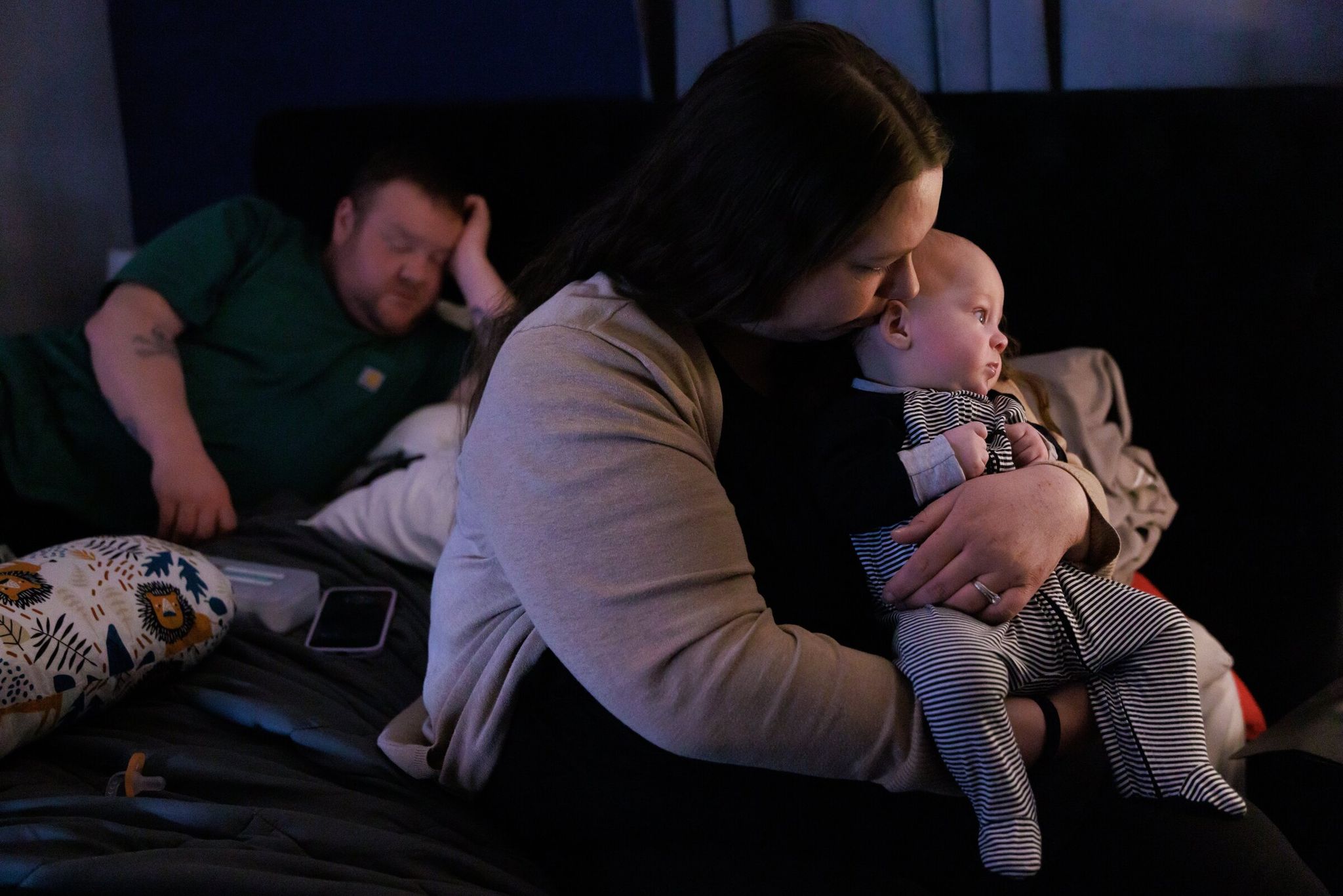 Kevin Week and Jessica Adams relax with baby Jackson at their home in Pacific, months after the flood. Before the December downpour they had been able to spend a few precious nights at home after living at Seattle Children’s, where Jackson’s twin sister remained hospitalized. (Erika Schultz / The Seattle Times)