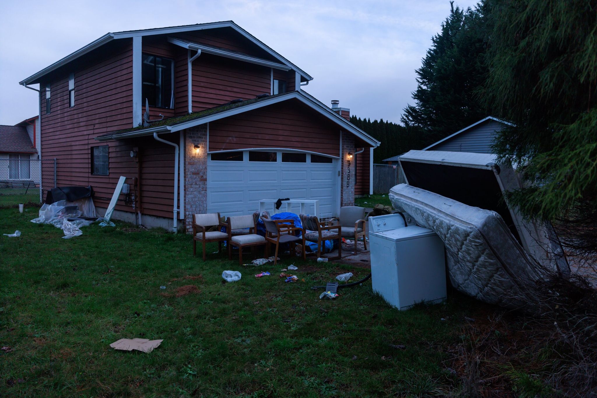Mattresses, furniture and appliances damaged by the flood became common sights in front of homes on White River Drive. The city briefly provided dumpsters but soon removed them, forcing residents to drive to waste collection sites to discard ruined belongings. (Erika Schultz / The Seattle Times)
