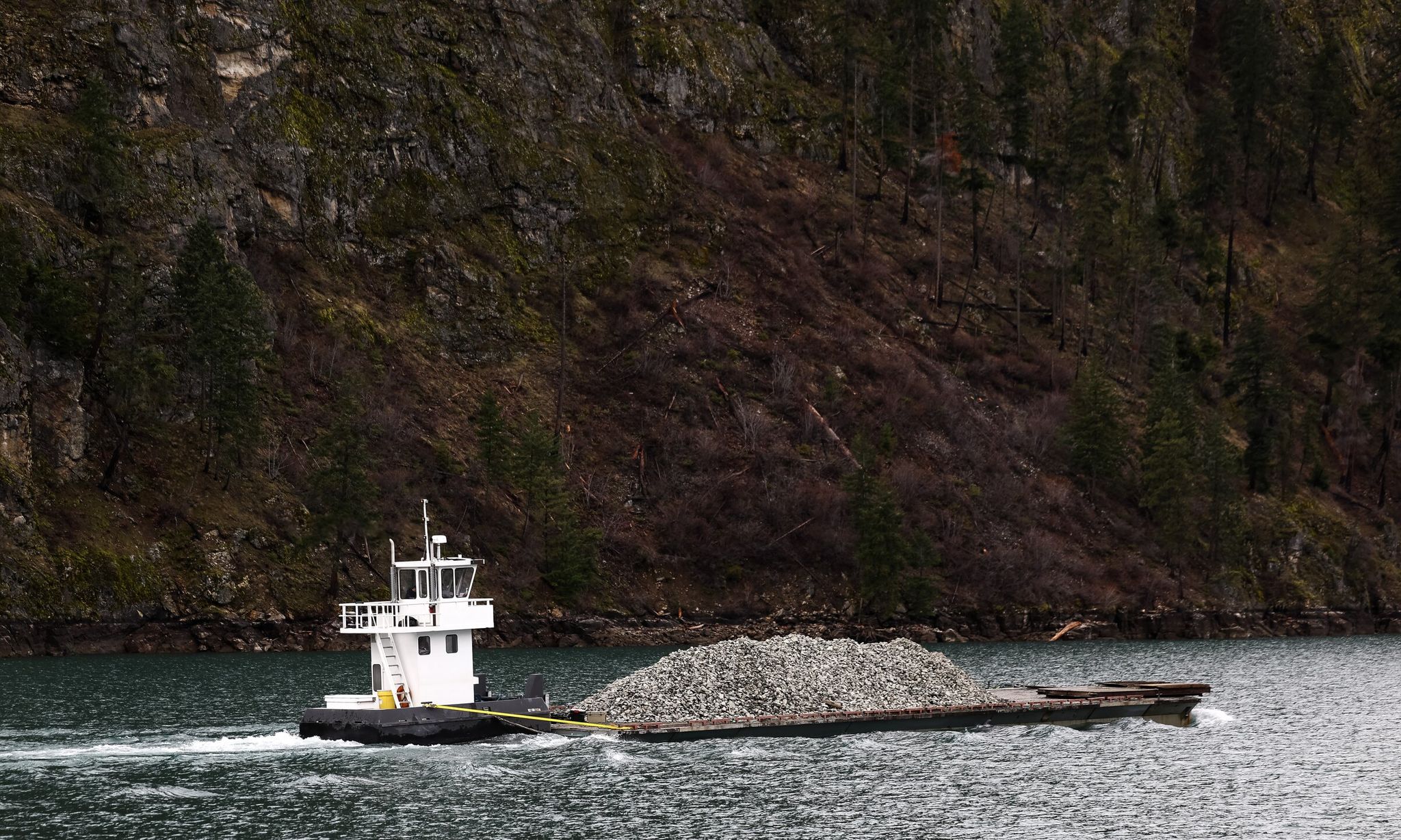 A barge operated by Mountain Barge Services carried 250 tons of quarry rock up Lake Chelan in February in Stehekin. (Nick Wagner / The Seattle Times)