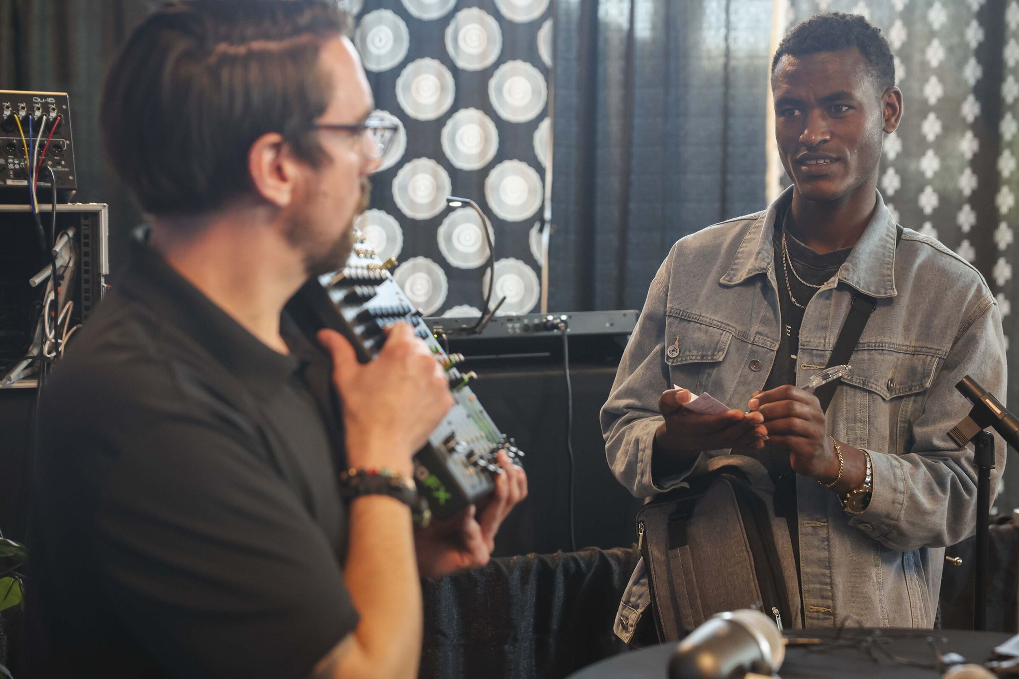 Alex Ren (left) instructs students while Binyam Hegano, 23, (right) takes notes during the workshop on April 30. (Ivy Ceballo / The Seattle Times)