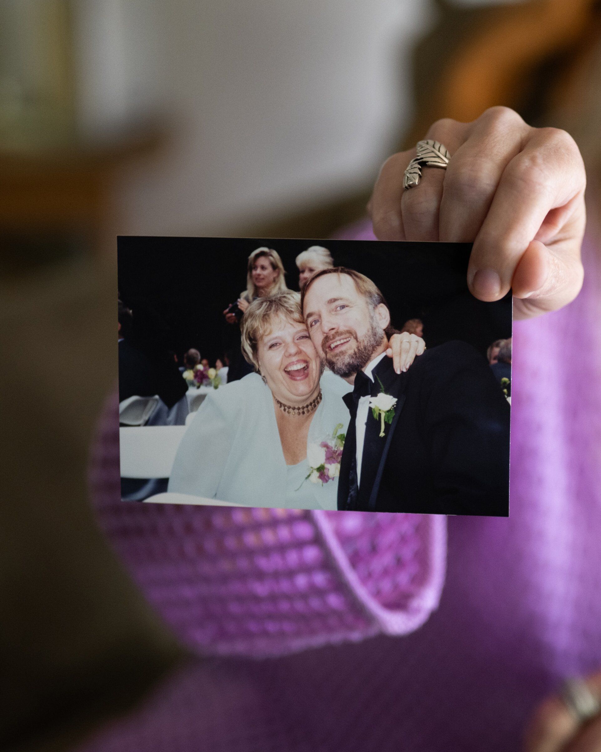 Heidi Hendrickson holds up a family photo of her parents, Linda and Stan Lawson, who were married for more than 50 years, at her home near Seattle in April. Some consider the regular feeding of late-stage dementia patients to be nonnegotiable, while others see it as extending life unnecessarily. (Chona Kasinger/The New York Times)
