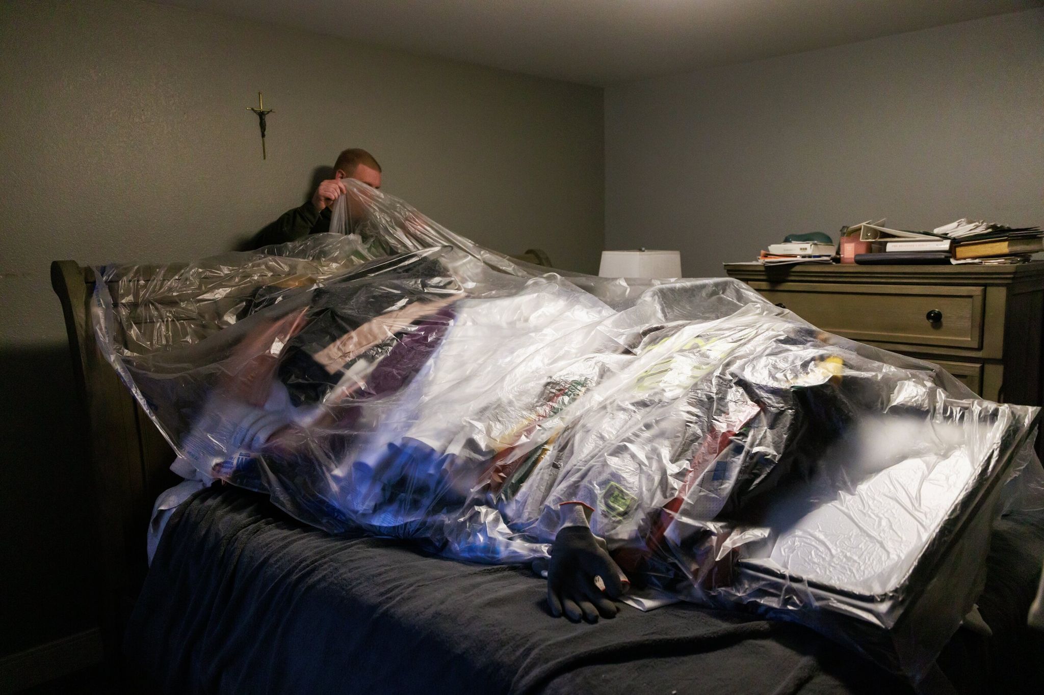 Trevor Curtis repairs his house and sorts items laid out on his bed after the December flood in Pacific. Before the flood, he and his partner had been converting a spare room into a nursery for their first child, who was due to be born. (Erika Schultz / The Seattle Times)