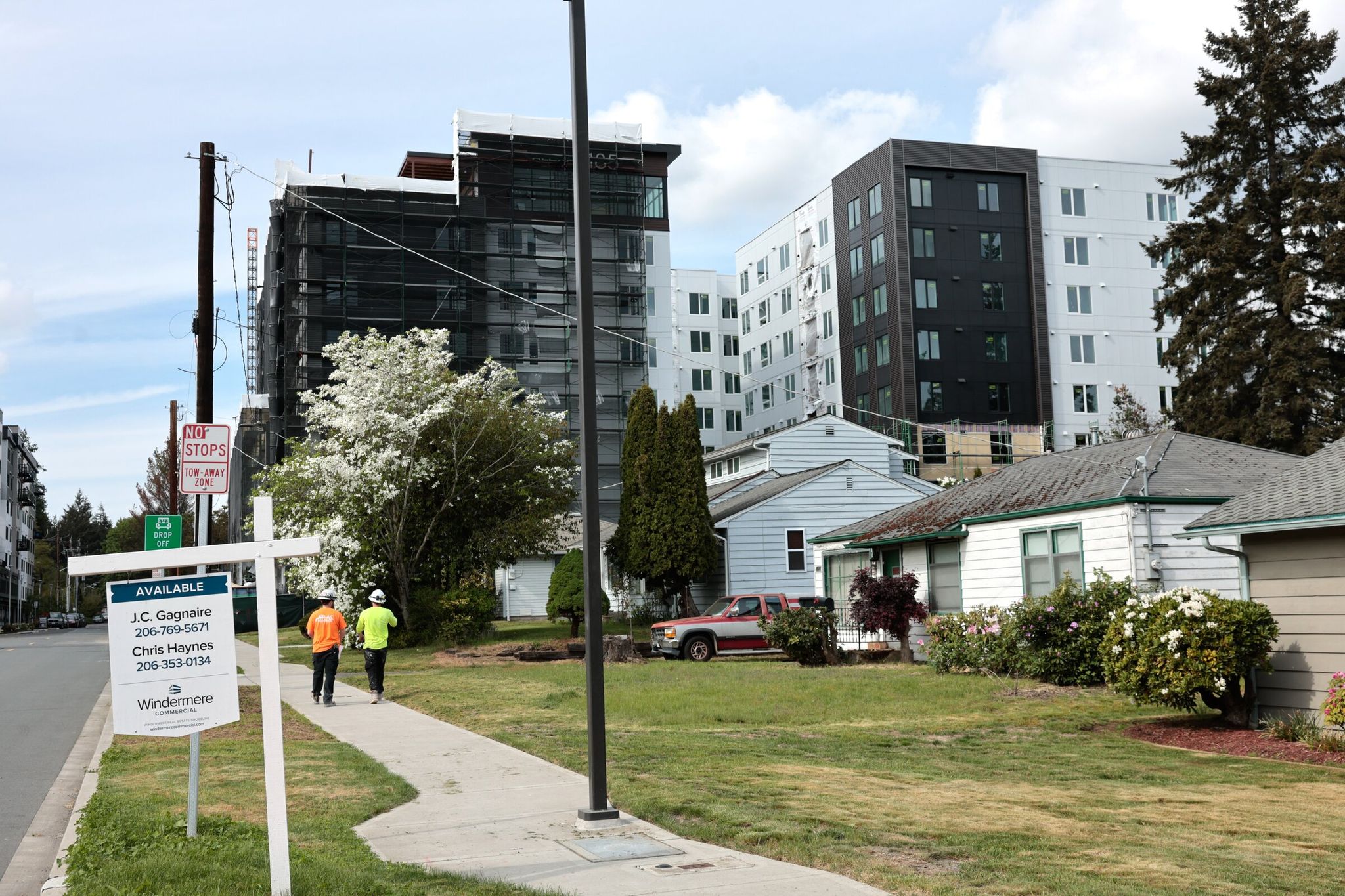 Small houses for sale just steps from the Shorewood North/185th Street light-rail station look tiny next to new residential development. (Karen Ducey / The Seattle Times)