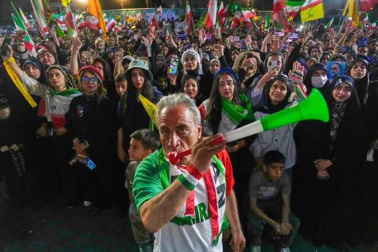 A man wearing a shirt bearing Iran’s national soccer team logo blows a plastic trumpet during a pro-government gathering in support of Iran’s World Cup team at Islamic Revolution Square in Tehran, Iran, Wednesday, May 13, 2026. (Vahid Salemi / The Associated Press)