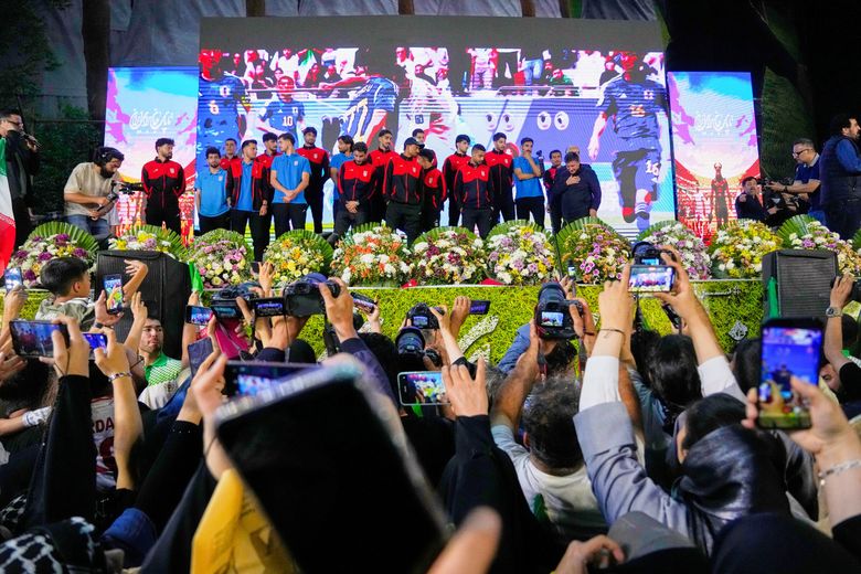 Iran’s national soccer team players are greeted by supporters during a pro-government gathering in support of Iran’s World Cup team before their departure for training and friendly matches in Turkey at Islamic Revolution Square in Tehran, Iran, Wednesday, May 13, 2026. (Vahid Salemi / The Associated Press)