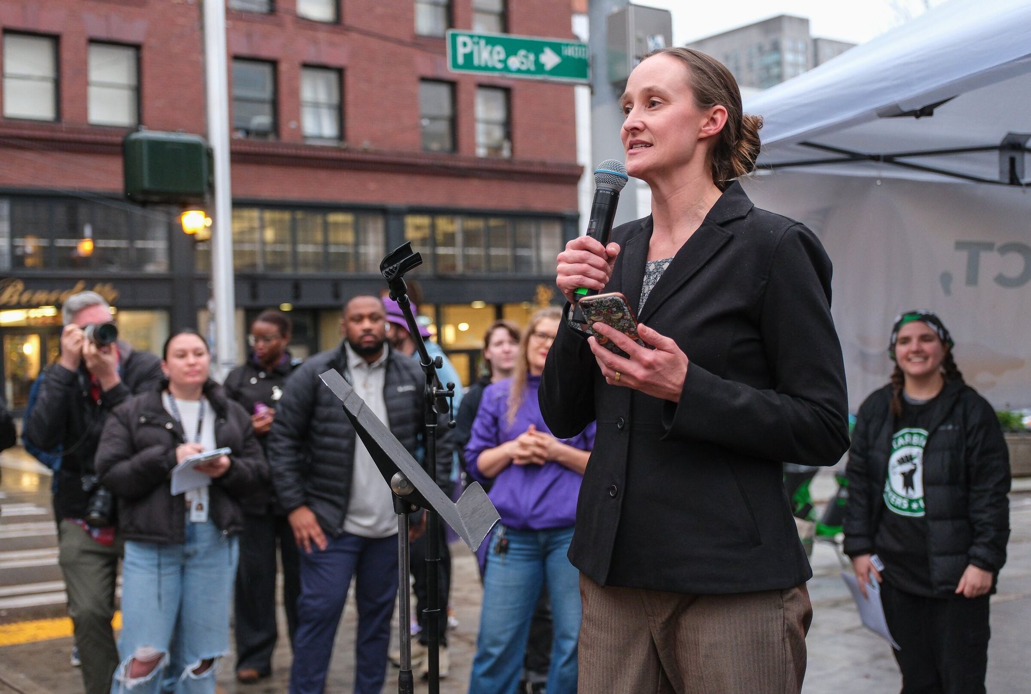 Katie Wilson, then Seattle’s mayor-elect, addresses striking Starbucks baristas outside the former Roastery on Capitol Hill in November. (Dean Rutz / The Seattle Times)