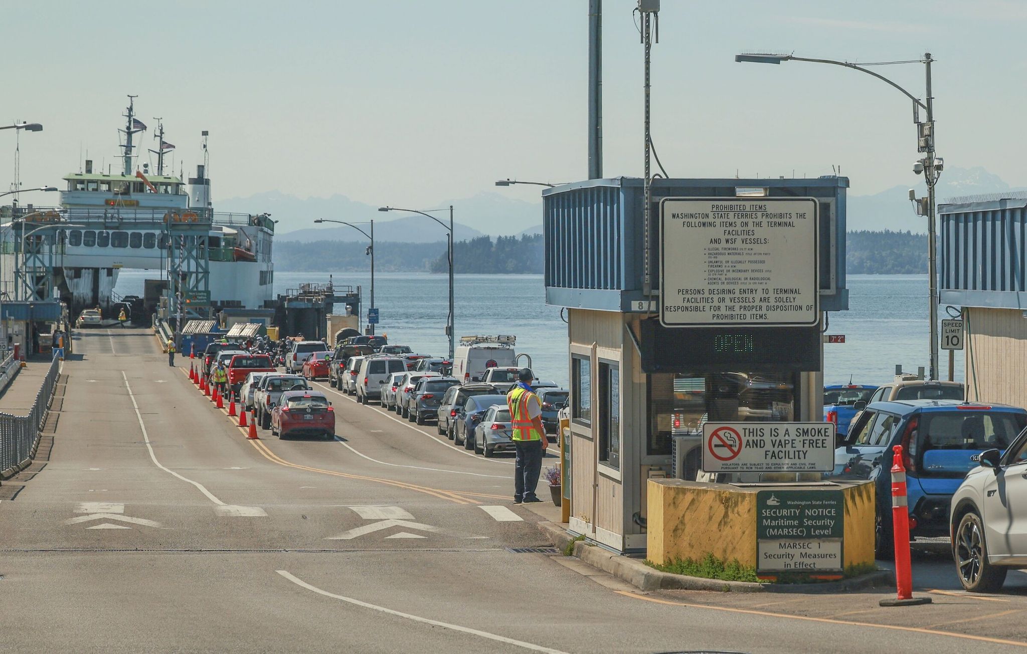 The busiest ferry season starts now. Here, passengers wait in line at the Fauntleroy Ferry Terminal in West Seattle. (Ivy Ceballo / The Seattle Times, 2024)