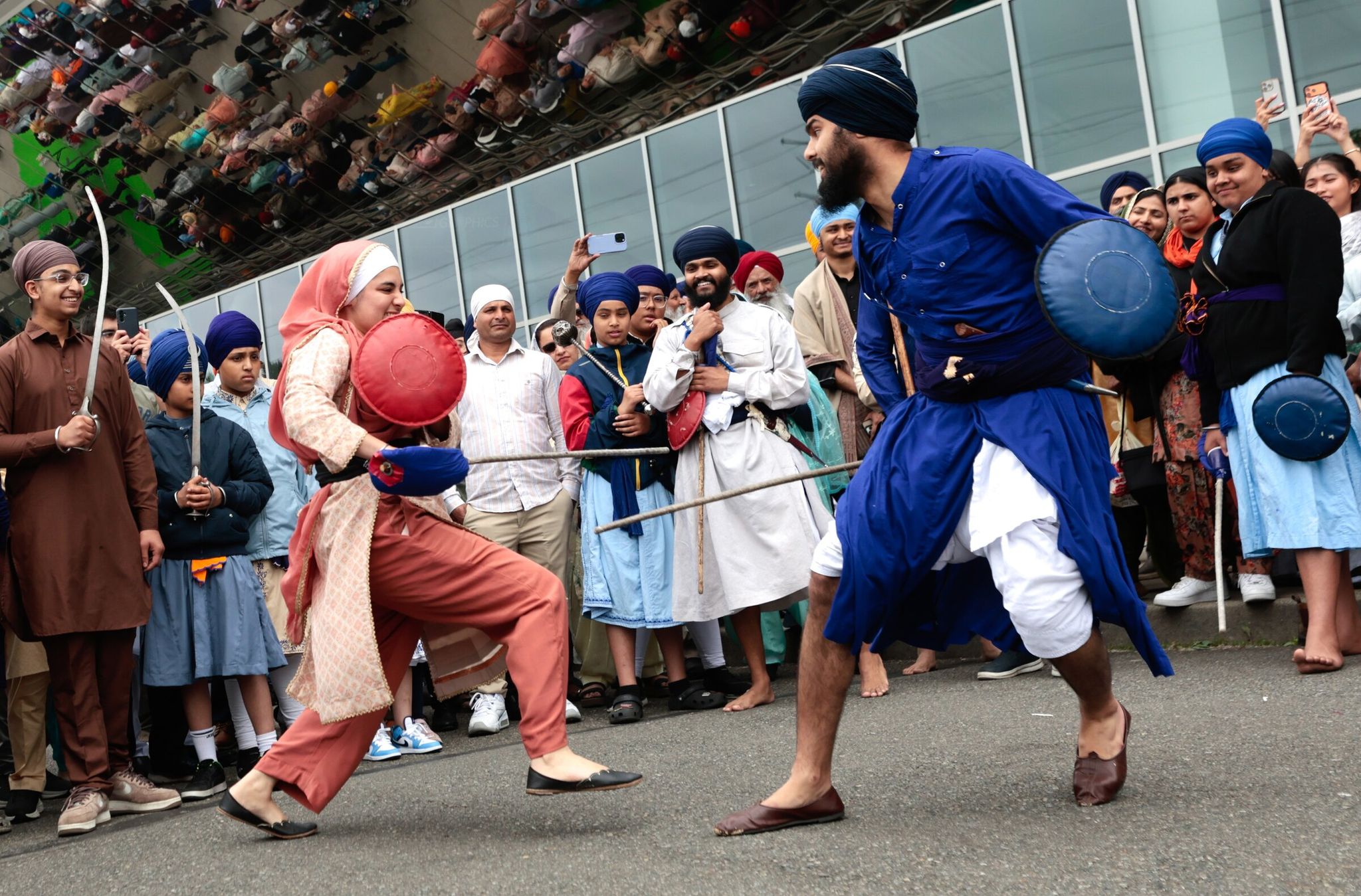 Martial-arts demonstrators Jaskiran Kaur (left) and Jasjit Singh of the Gatka team perform at ShoWare Center. (Karen Ducey / The Seattle Times)