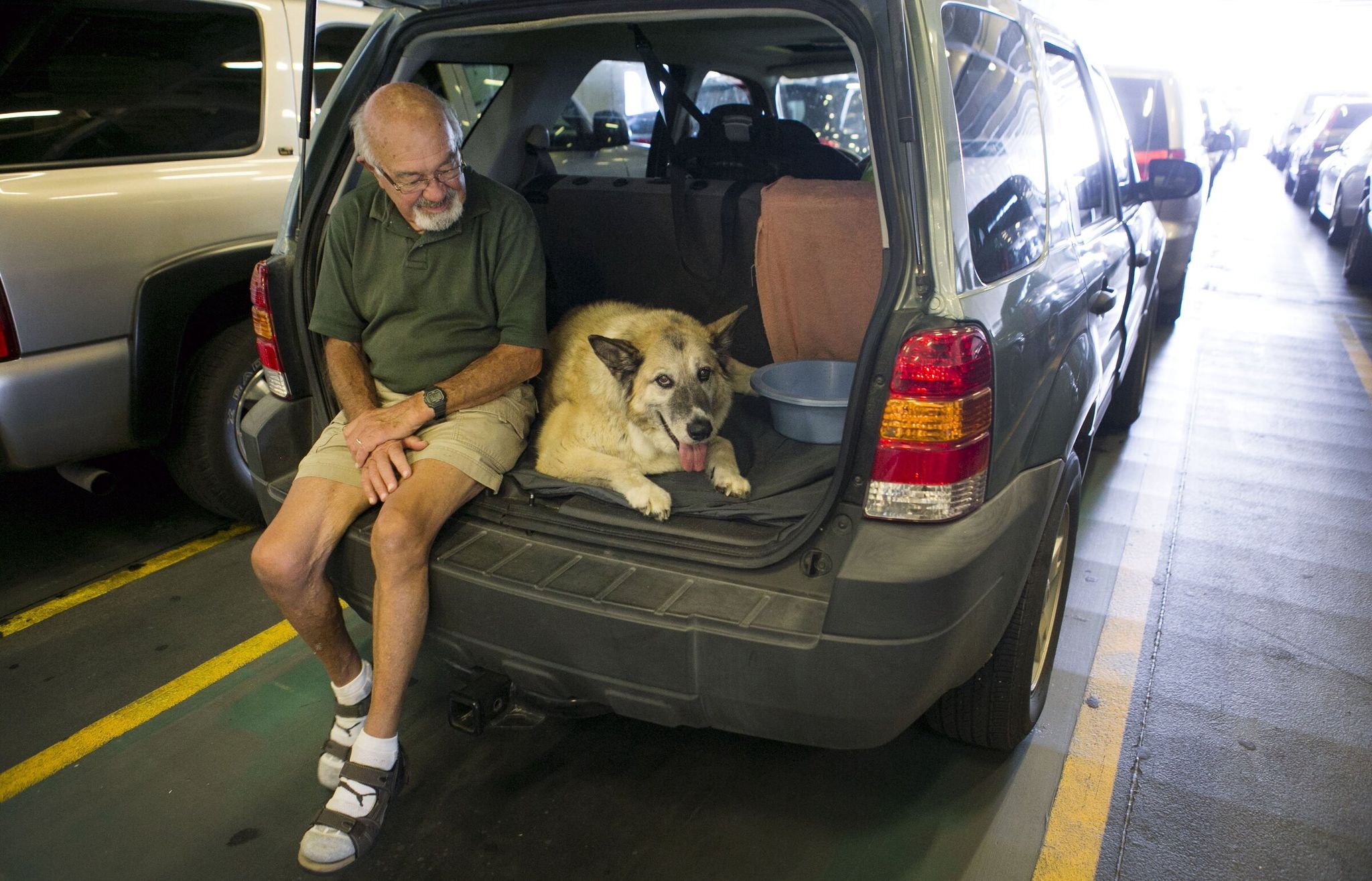 Neil Molenaar of East Wenatchee sits with his dog Chloe aboard the MV Puyallup state ferry from Bainbridge Island to Seattle. (Bettina Hansen / The Seattle Times, 2014)