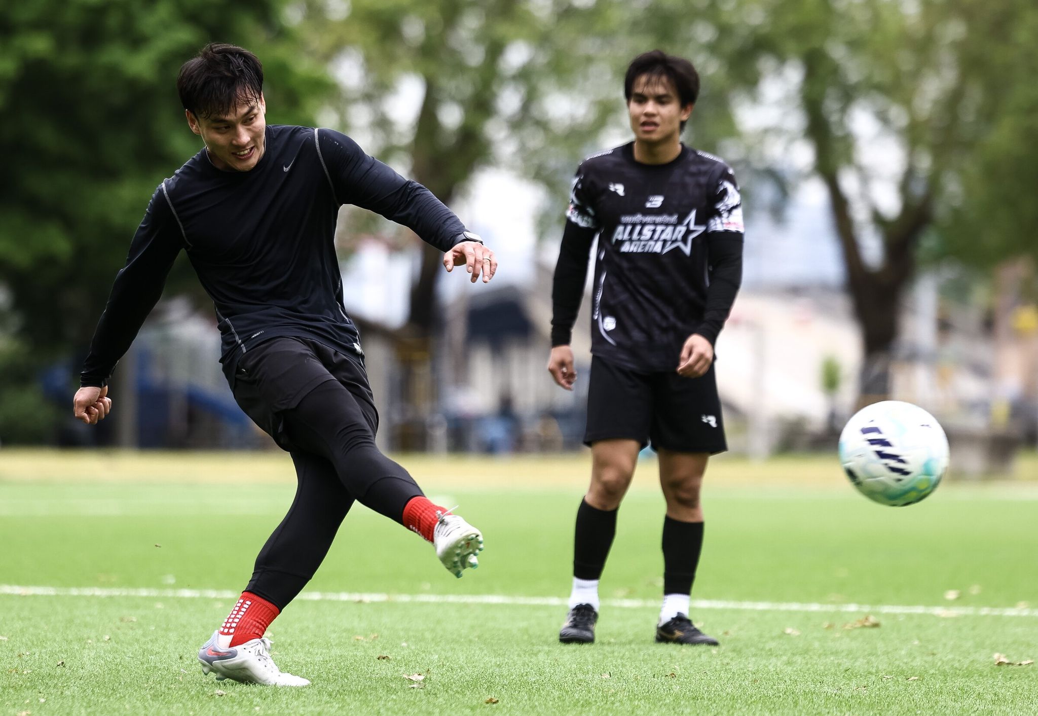 Ben Nguyen practices taking penalty kicks with his friend Hoi Le after they finished a match. (Nick Wagner / The Seattle Times)