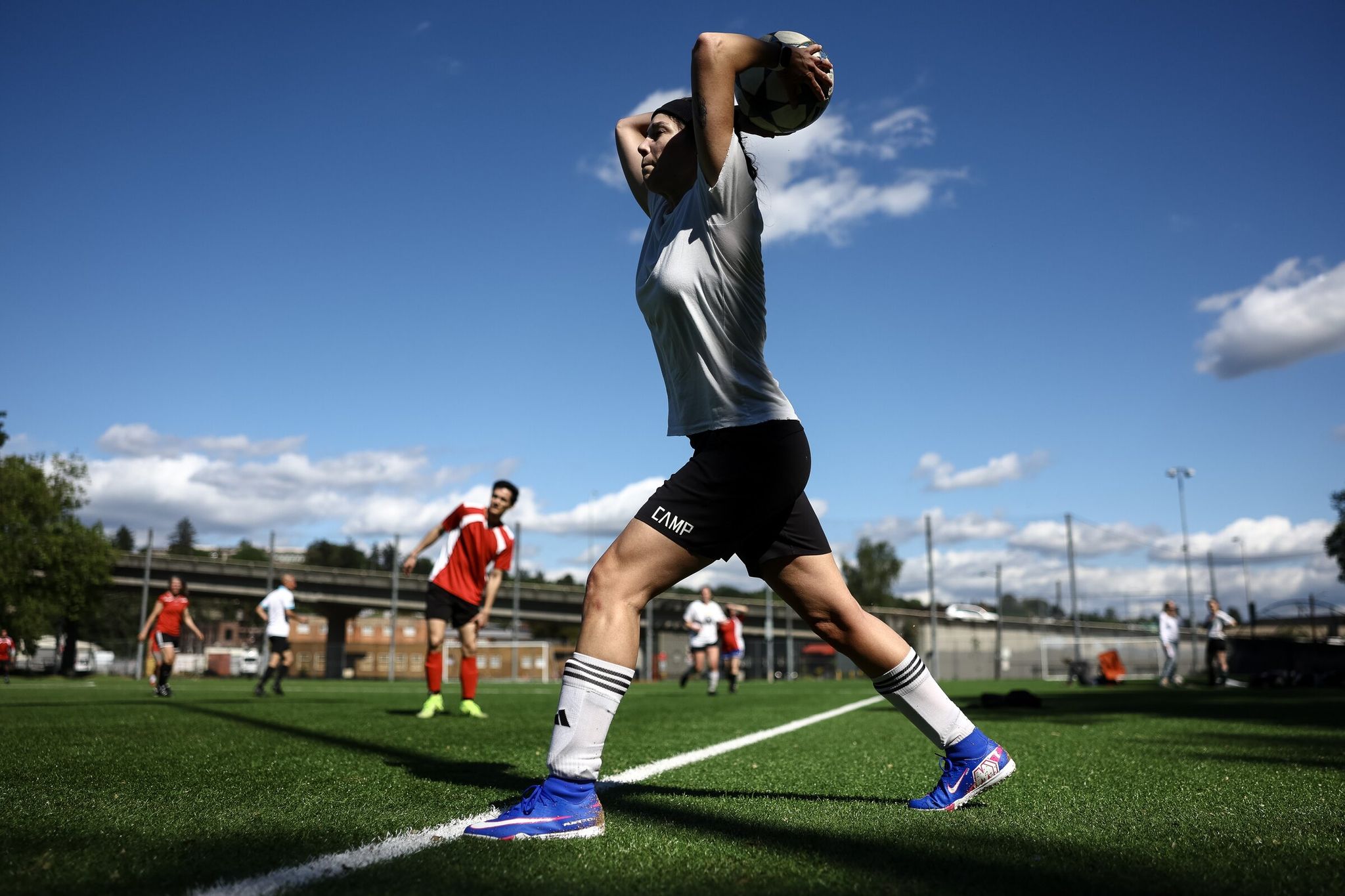 Meghan Mock resumes play with a throw-in during a Recreational Adult Team Soccer match at Georgetown Playfield on May 17 in Seattle. (Nick Wagner / The Seattle Times)