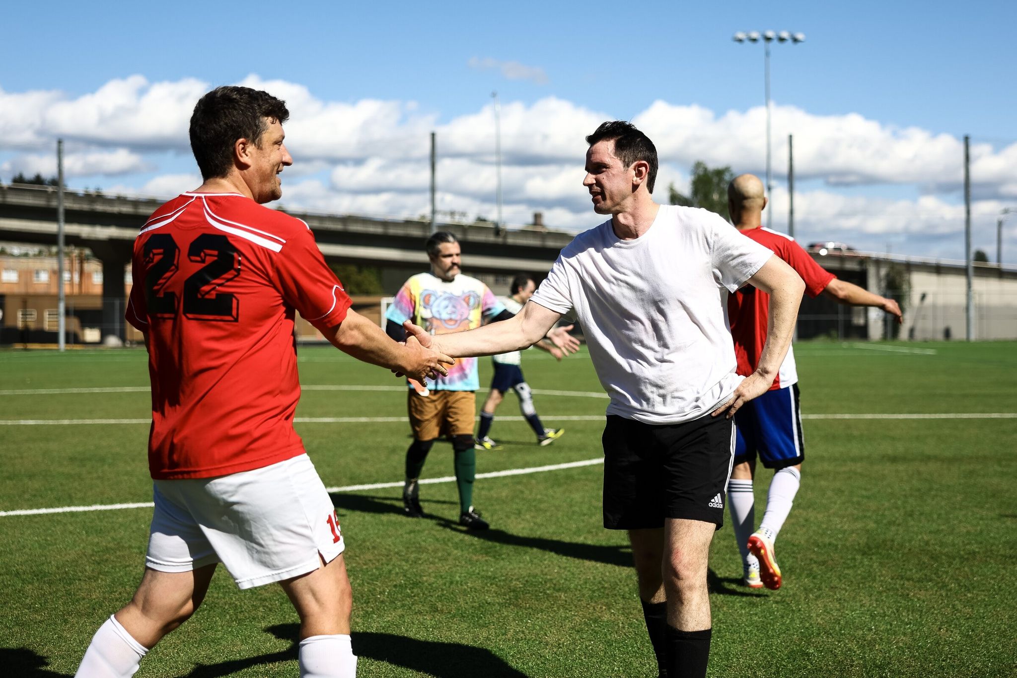 Players exchange handshakes after a friendly match. (Nick Wagner / The Seattle Times)