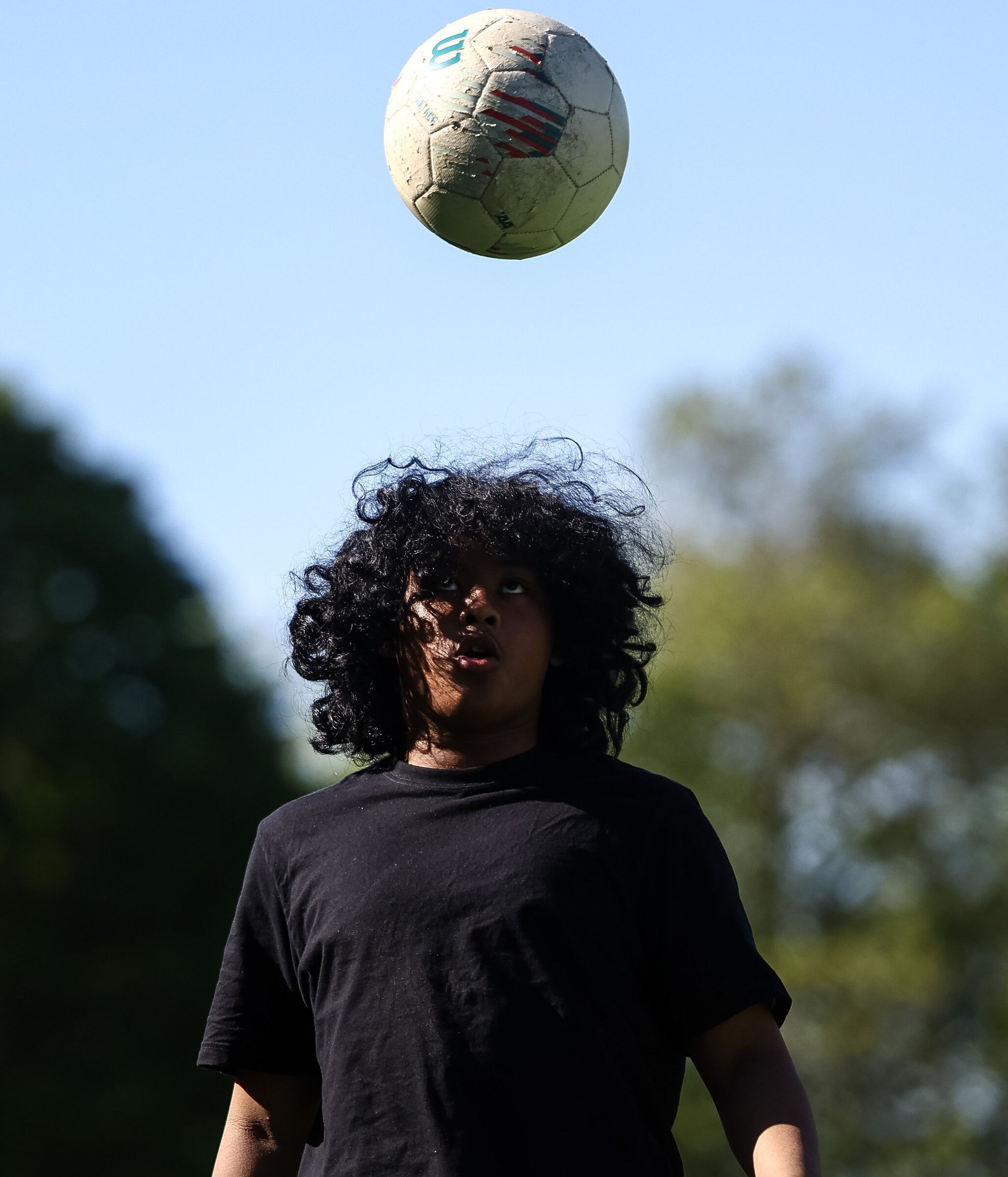 Krillion Lockhart practices tossing a soccer ball at Georgetown Playfield. (Nick Wagner / The Seattle Times)