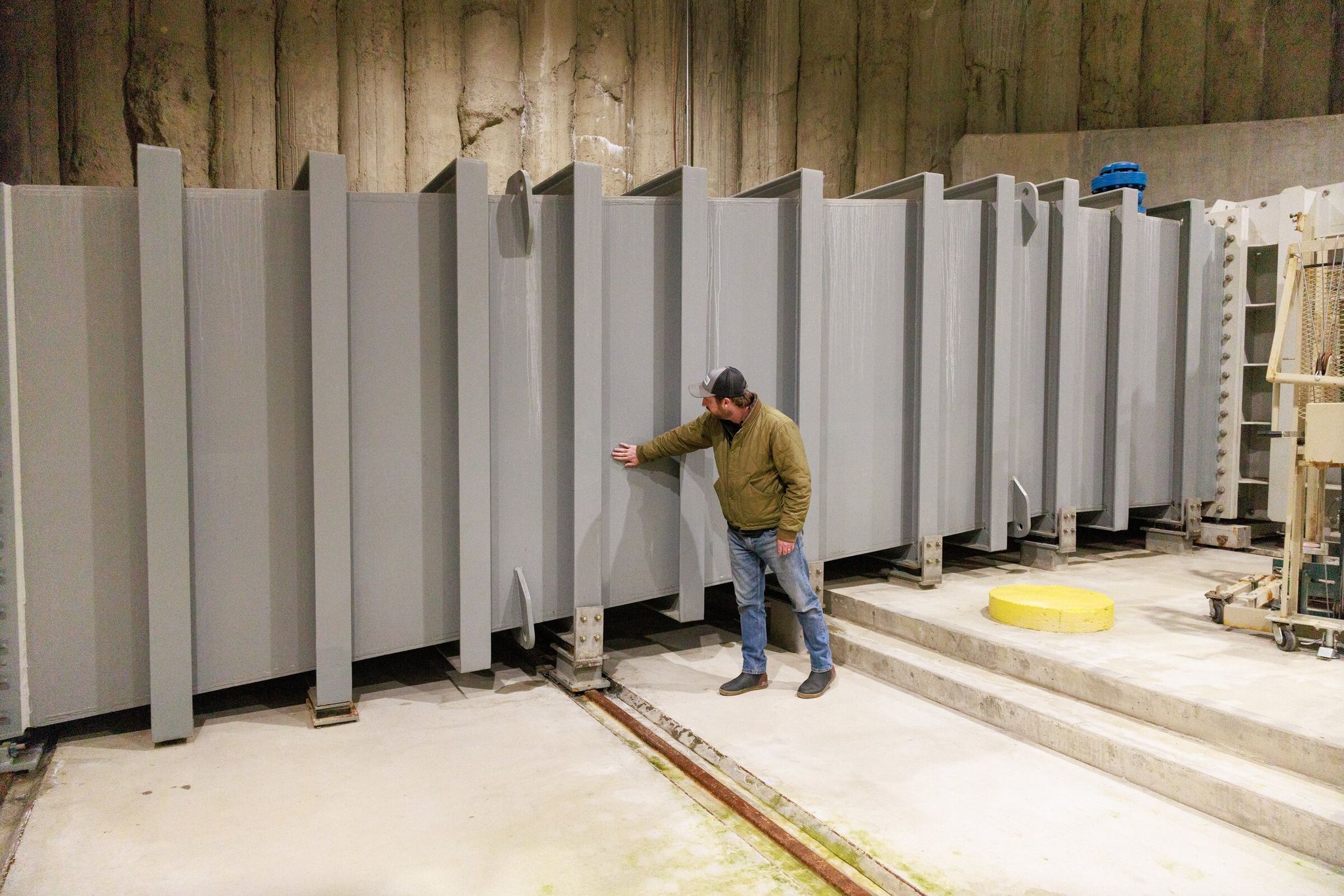 Brandon Parsons, director of river restoration with American Rivers, feels the condensation inside of the new Cle Elum Lake fish passage facilities. The project is anticipated to boost the sockeye return of the Yakima Basin. (Erika Schultz / The Seattle Times)