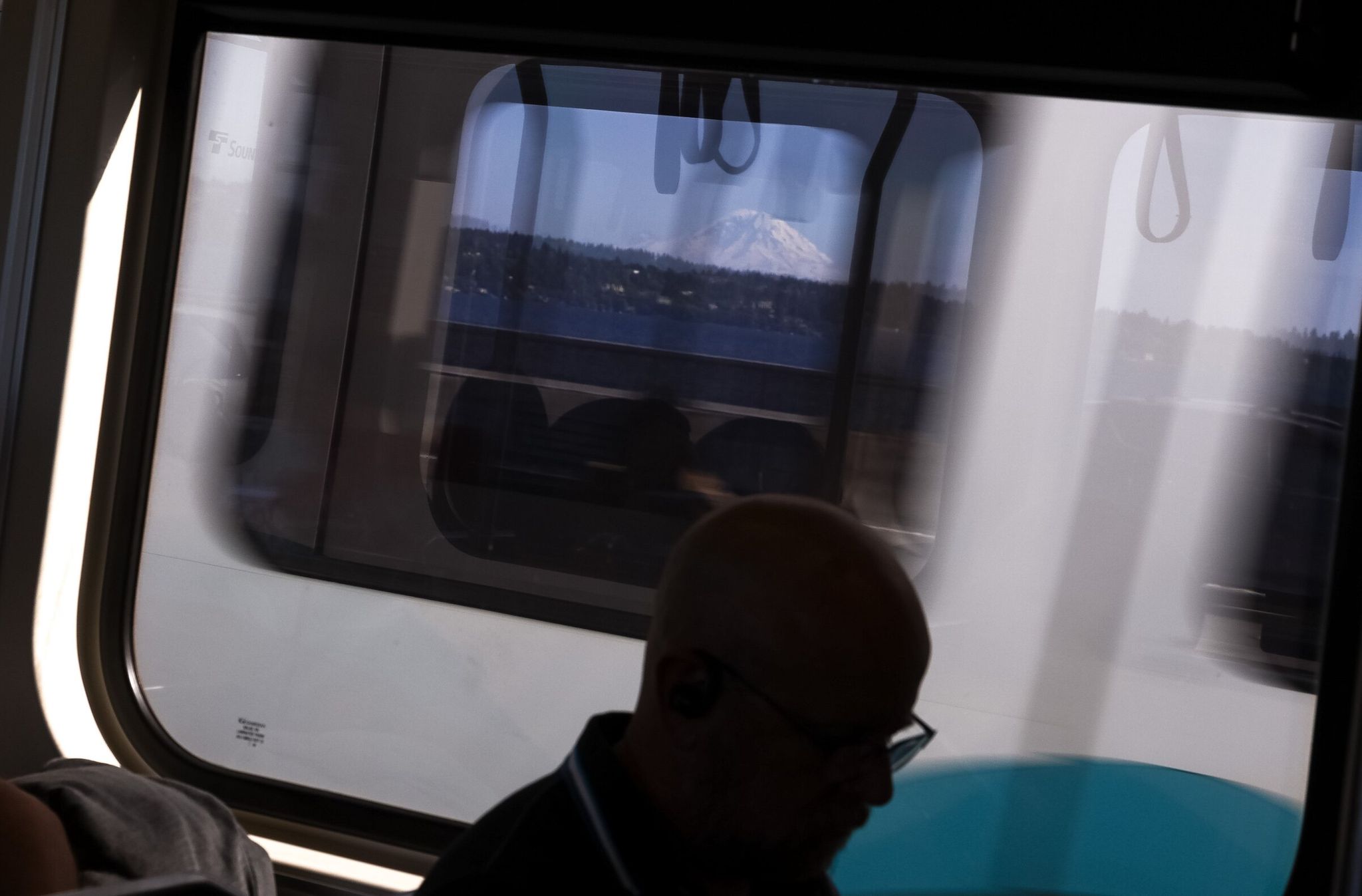 Mount Rainier is visible through a passing Sound Transit light-rail train crossing the I-90 floating bridge. Light-rail and highway closures will cause delays this weekend. (Nick Wagner / The Seattle Times)