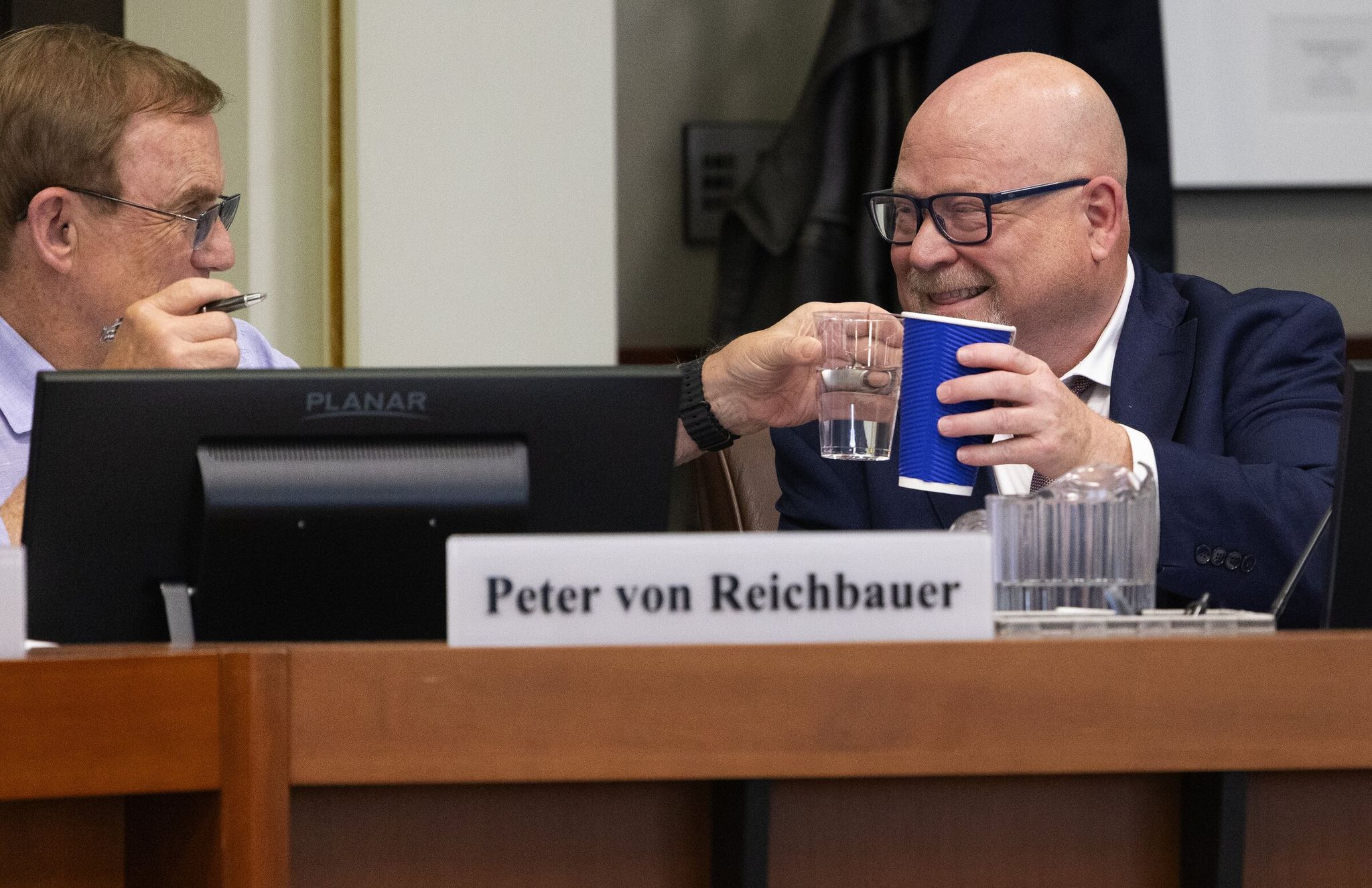 Tacoma mayor Thomas McLeod, right, toasts with Sound Transit board member Peter von Reichbauer after one of the series of Thursday votes. (Ken Lambert / The Seattle Times)