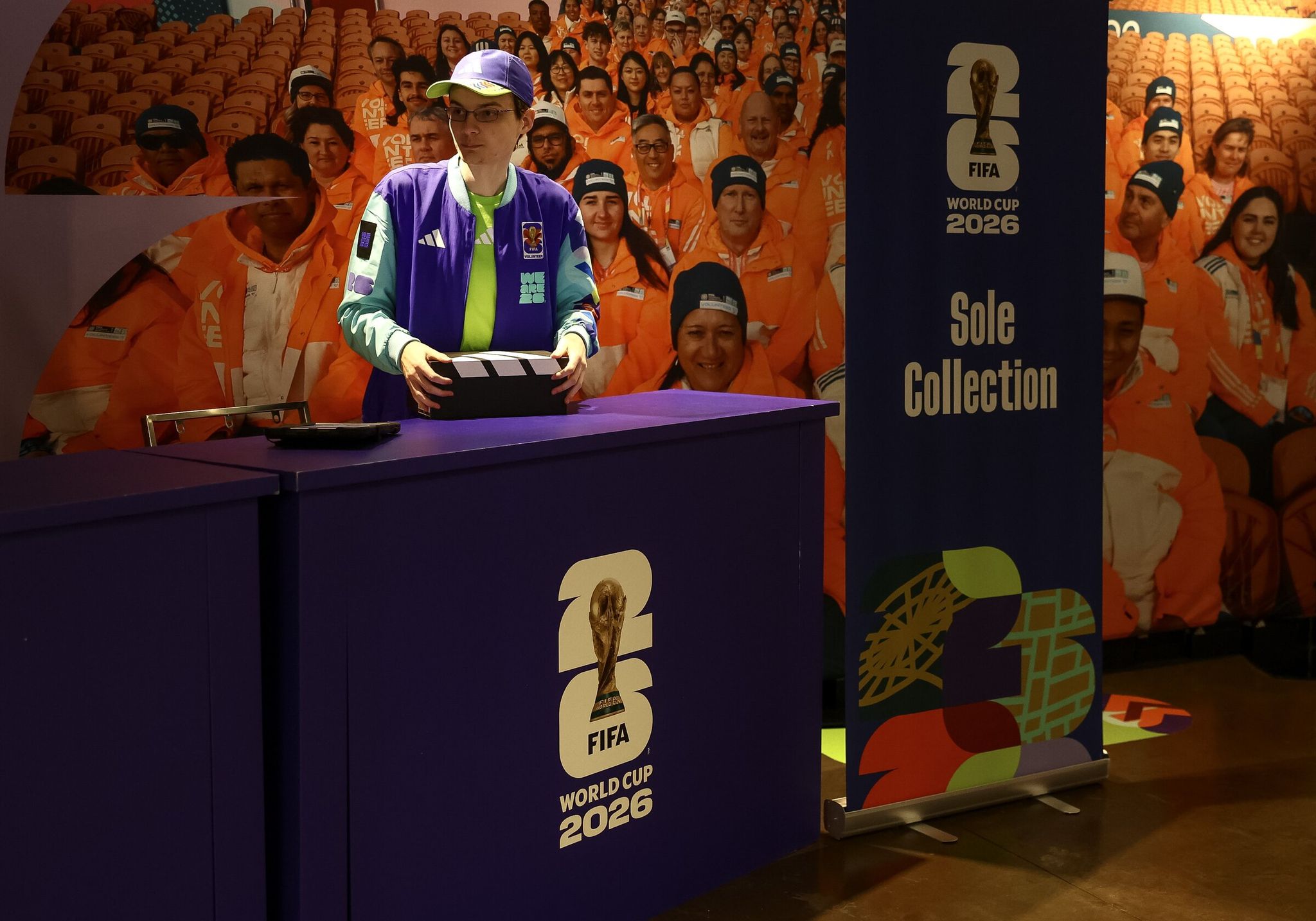 George Featherstone, World Cup volunteer, packs a box of shoes on May 20 in Seattle. (Nick Wagner / The Seattle Times)