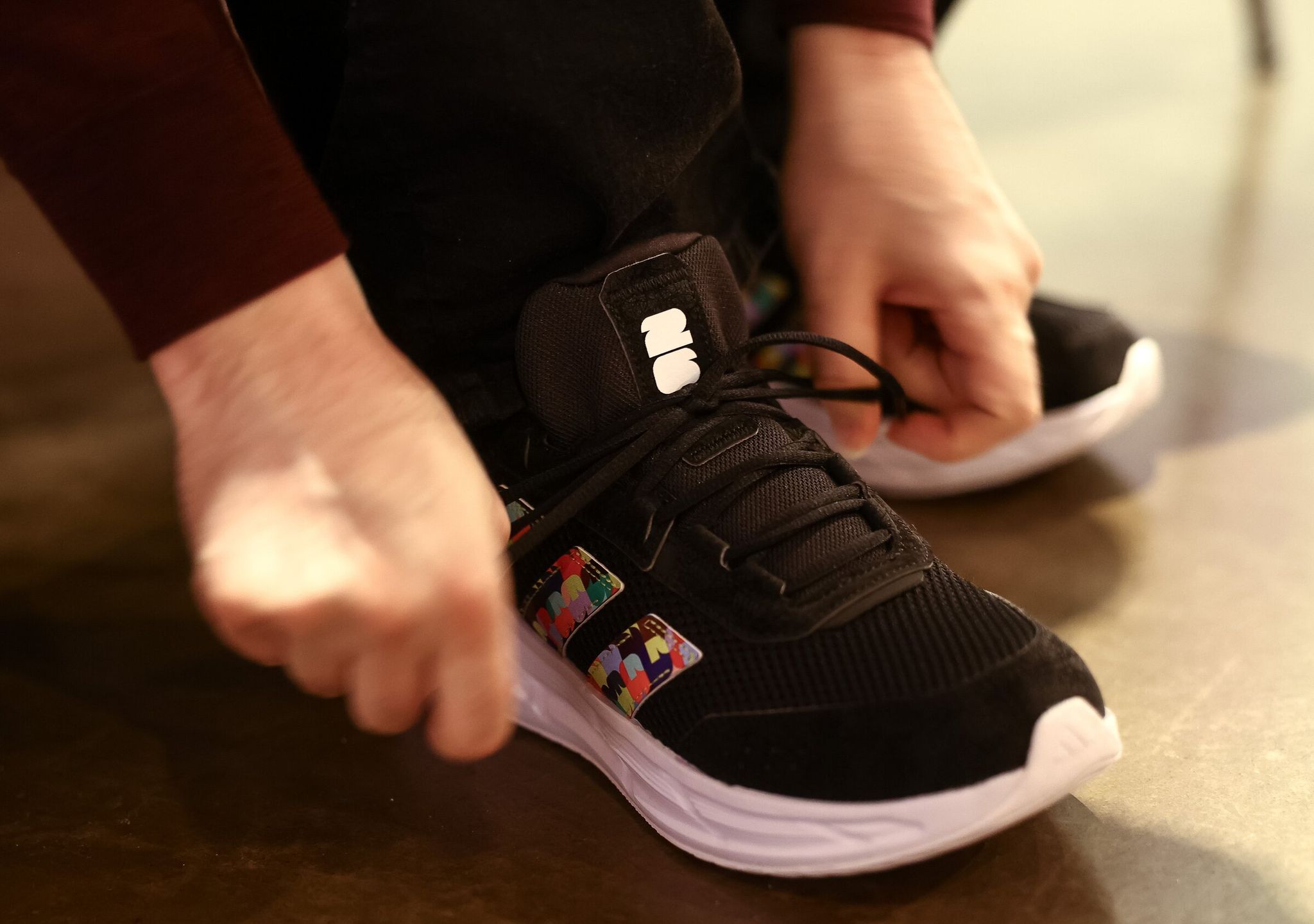 David Alvarez, FIFA World Cup volunteer, tries on a pair of shoes on May 20 in Seattle. (Nick Wagner / The Seattle Times)