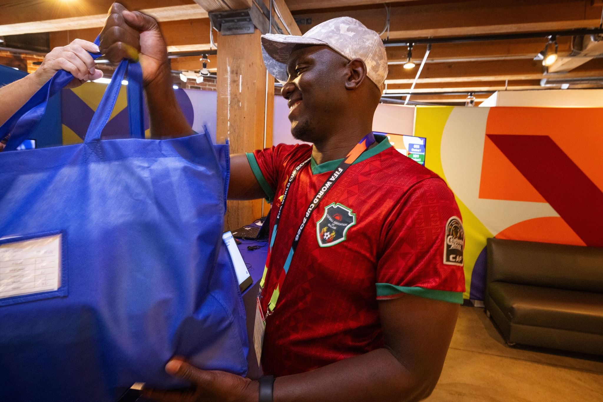 Oscar Singini of Everett receives his volunteer uniform for the FIFA World Cup on May 27. (Ken Lambert / The Seattle Times)