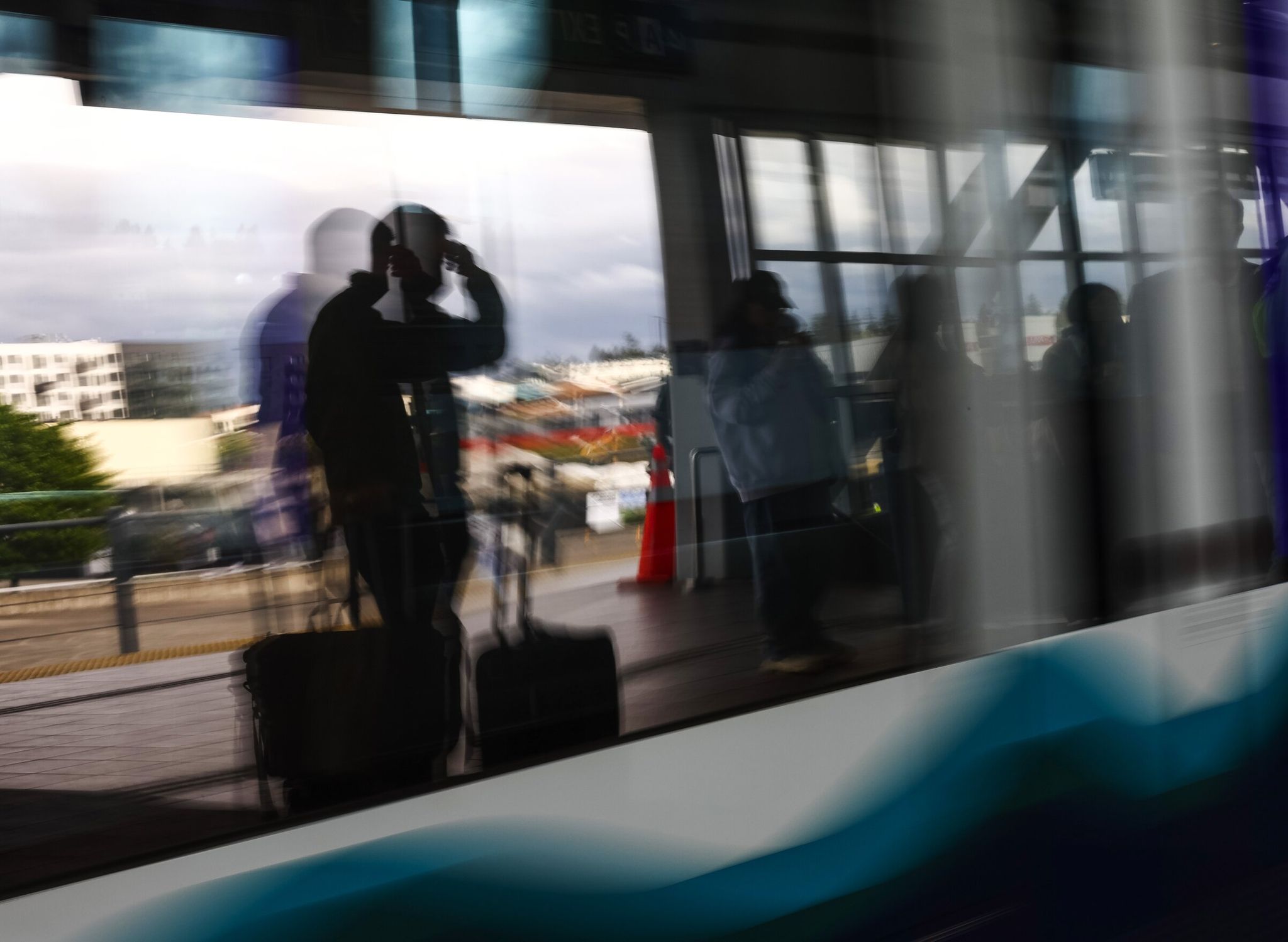 A Sound Transit Link light rail train arrives as passengers wait to board on May 13 in Seattle. (Nick Wagner / The Seattle Times)