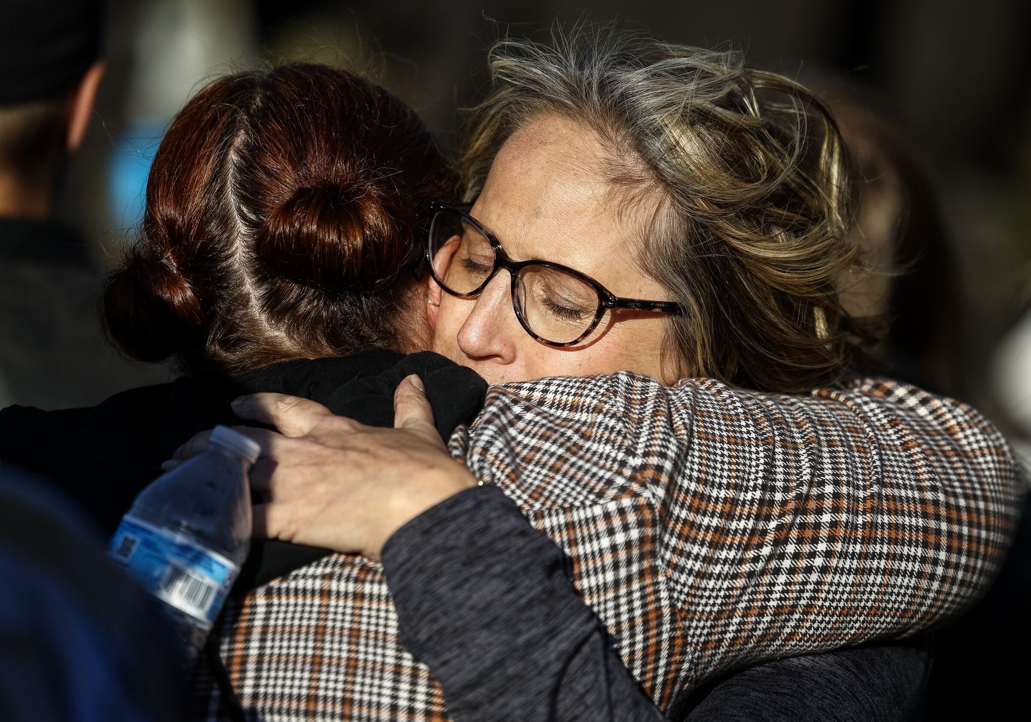 Sheri King embraces a woman during a vigil on Saturday. King’s two sons, Brad and Tyler Covington, were killed in Tuesday’s implosion at the Nippon Dynawave Packaging Co. facility.  (Nick Wagner / The Seattle Times)