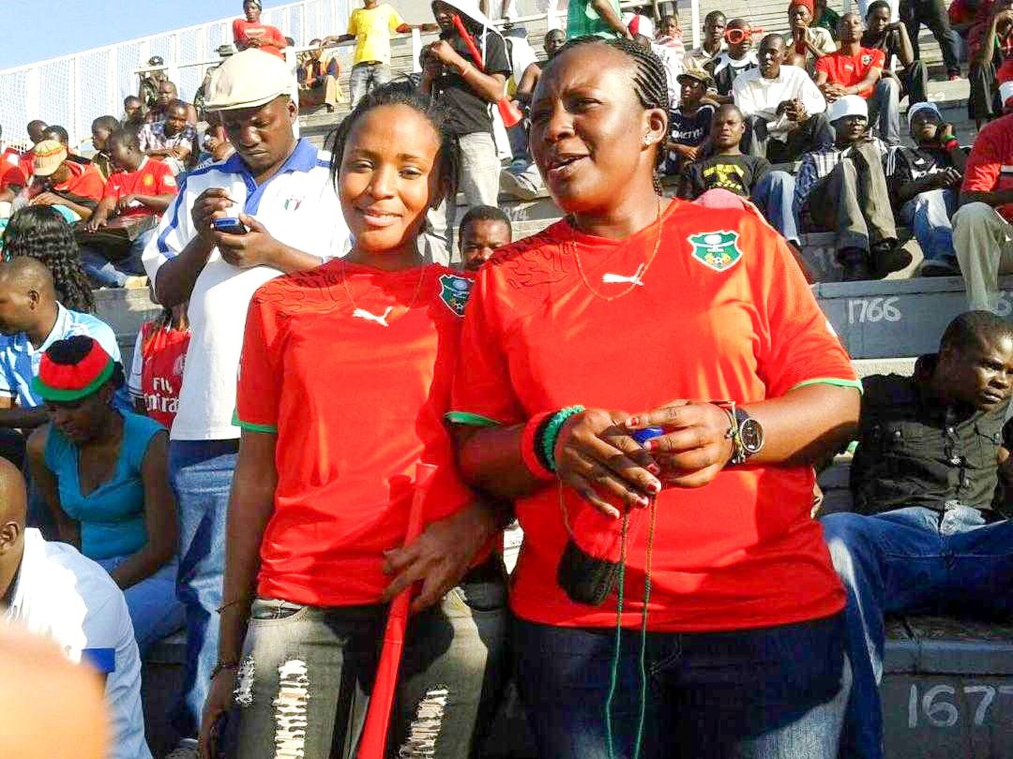 Emily Duwa (right) and her friend Rachel Makawa at Kamuzu Stadium in Blantyre, Malawi, during a 2012 FIFA World Cup qualifying match between Malawi and Nigeria. (Courtesy of Emily Duwa)