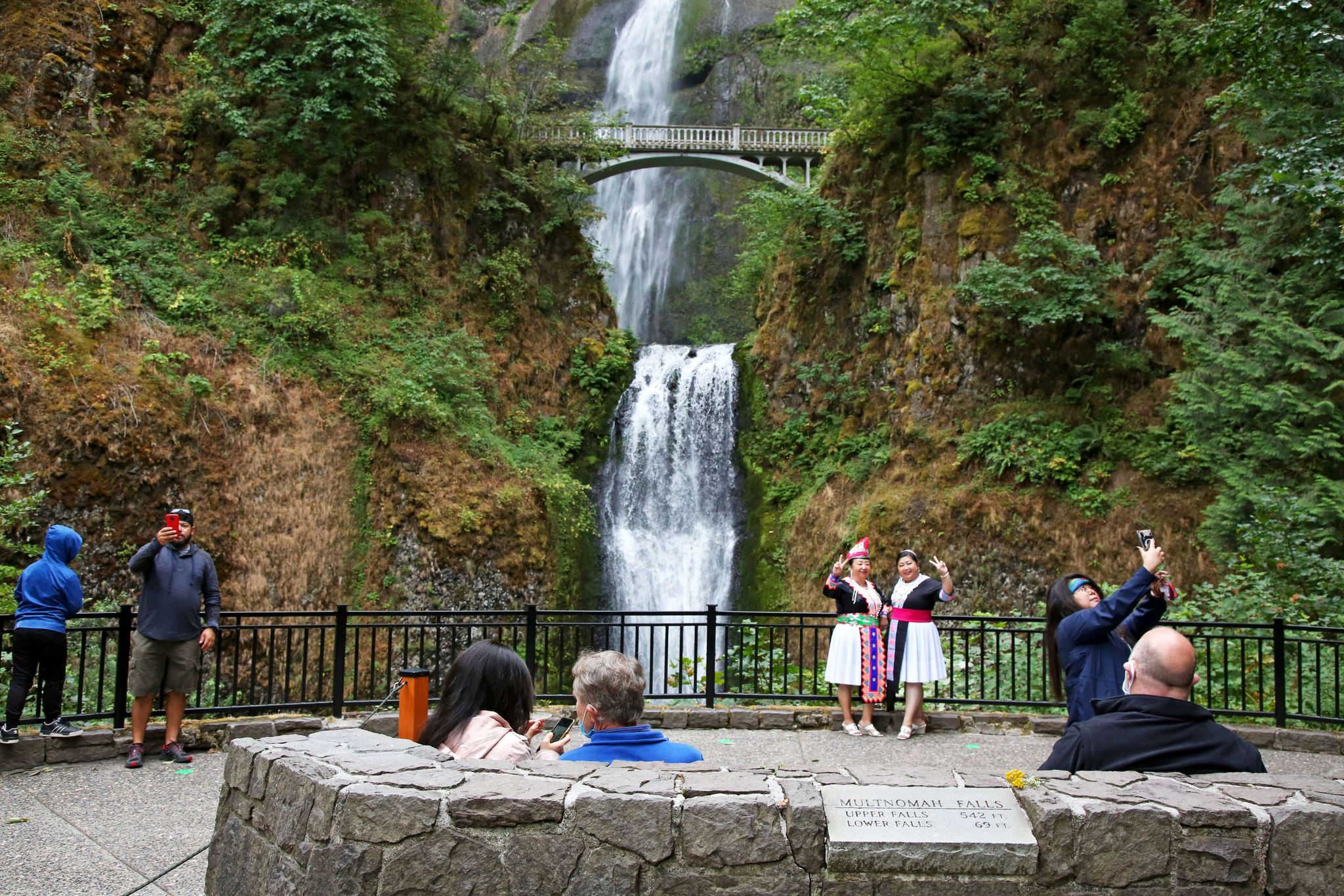 Visitors take photos at the base of Multnomah Falls. (Jamie Hale/oregonlive.com/TNS)