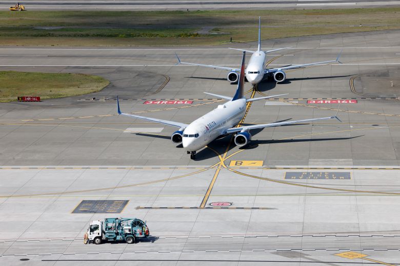 Airplanes taxi out of FAA-controlled airspace toward locally controlled airspace at the Seattle-Tacoma International Airport last month. Sea-Tac is piloting a new addition to its SAMS system to use cameras to track vehicles that are not equipped with transponders, but the project has been delayed for several years. (Karen Ducey / The Seattle Times)