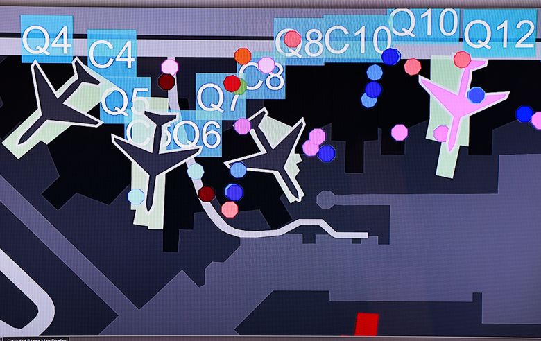 The Surface Airport Management System, seen on the screen, compiles data from several sources to show ramp controllers what is happening on the ground and in the surrounding airspace. (Karen Ducey / The Seattle Times)