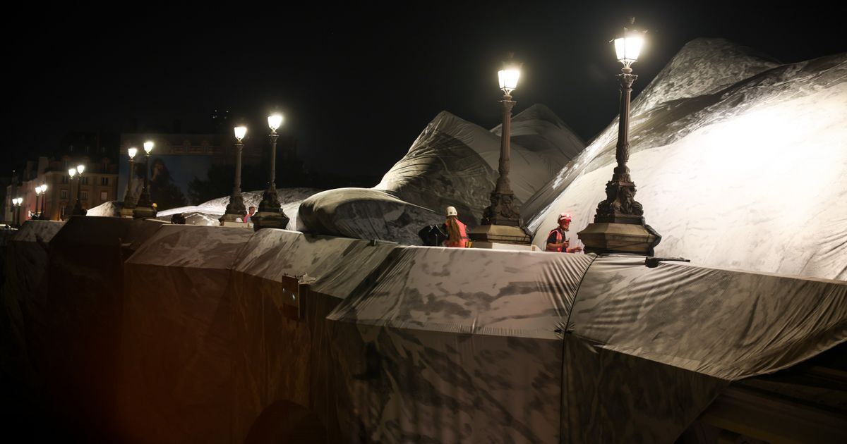 French artist JR begins his giant ‘cave’ art inflation over Paris’ oldest bridge