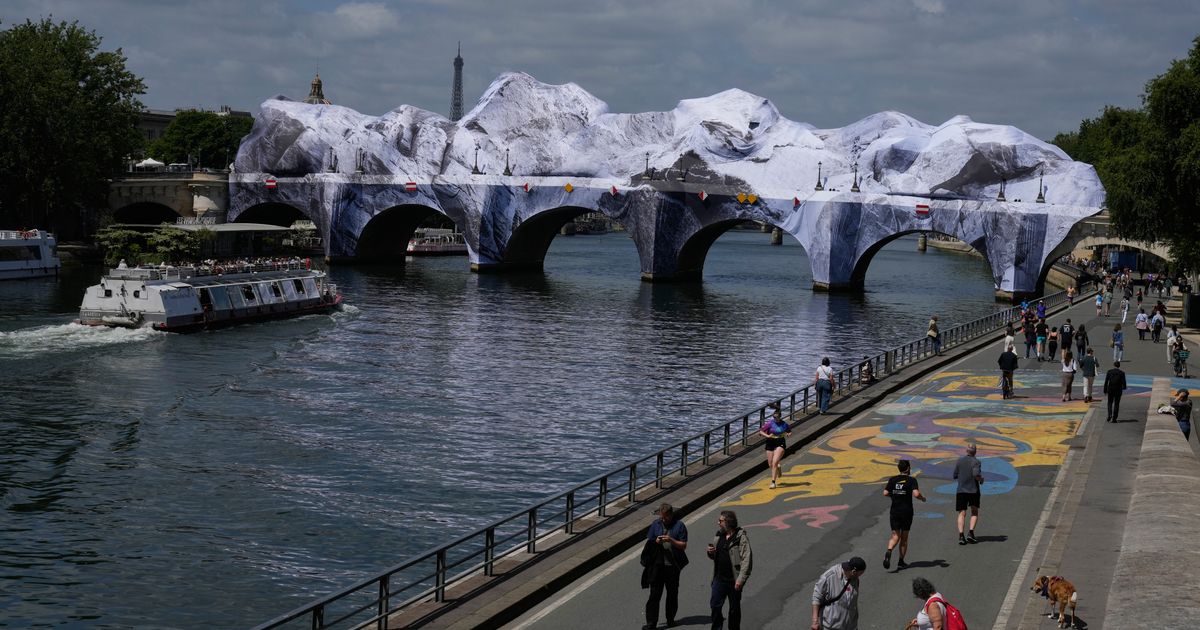 French artist JR begins his giant ‘cave’ art inflation over Paris’ oldest bridge