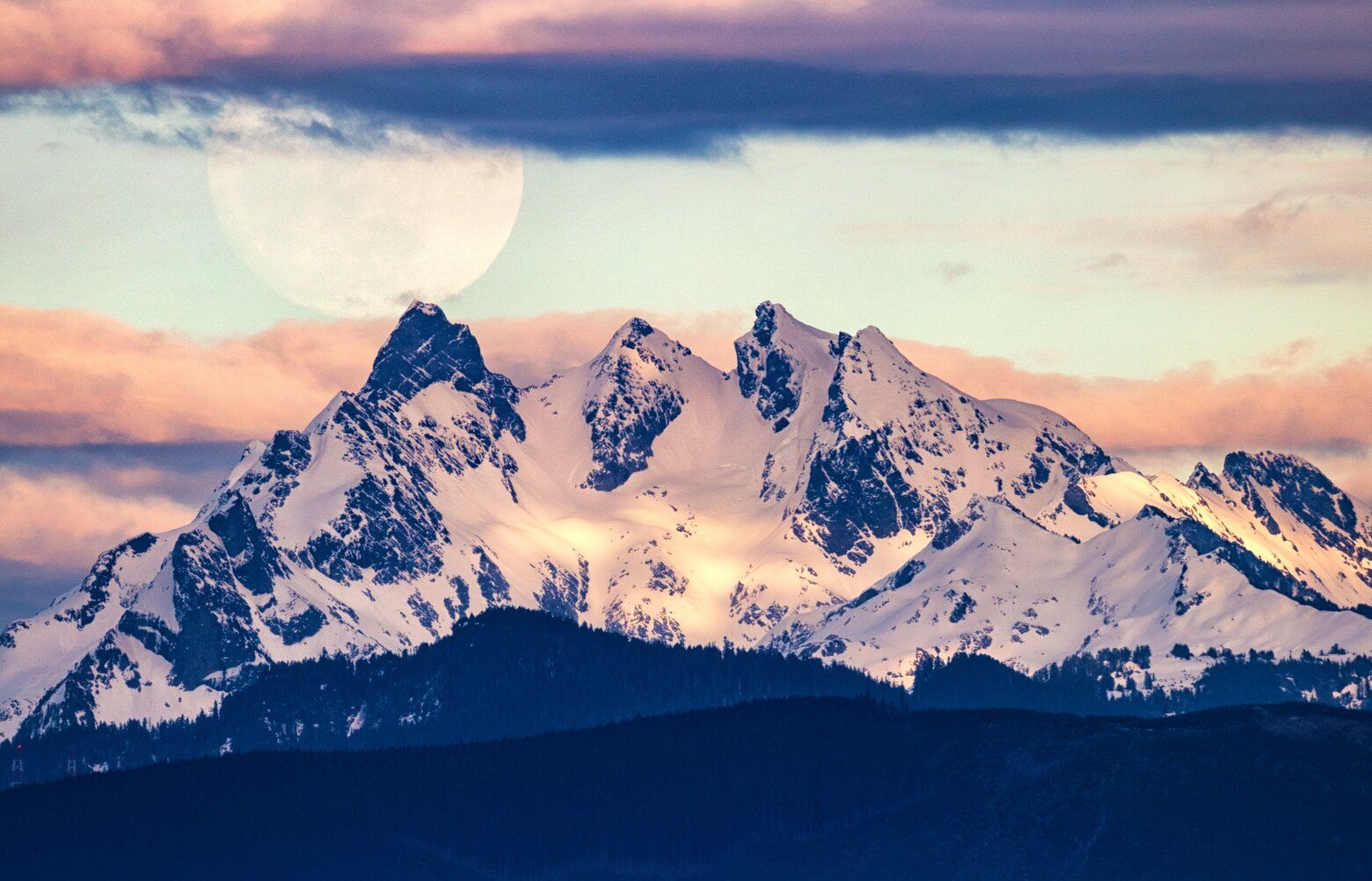 A huge moon looms over pink mountain twilight | The Seattle Times
