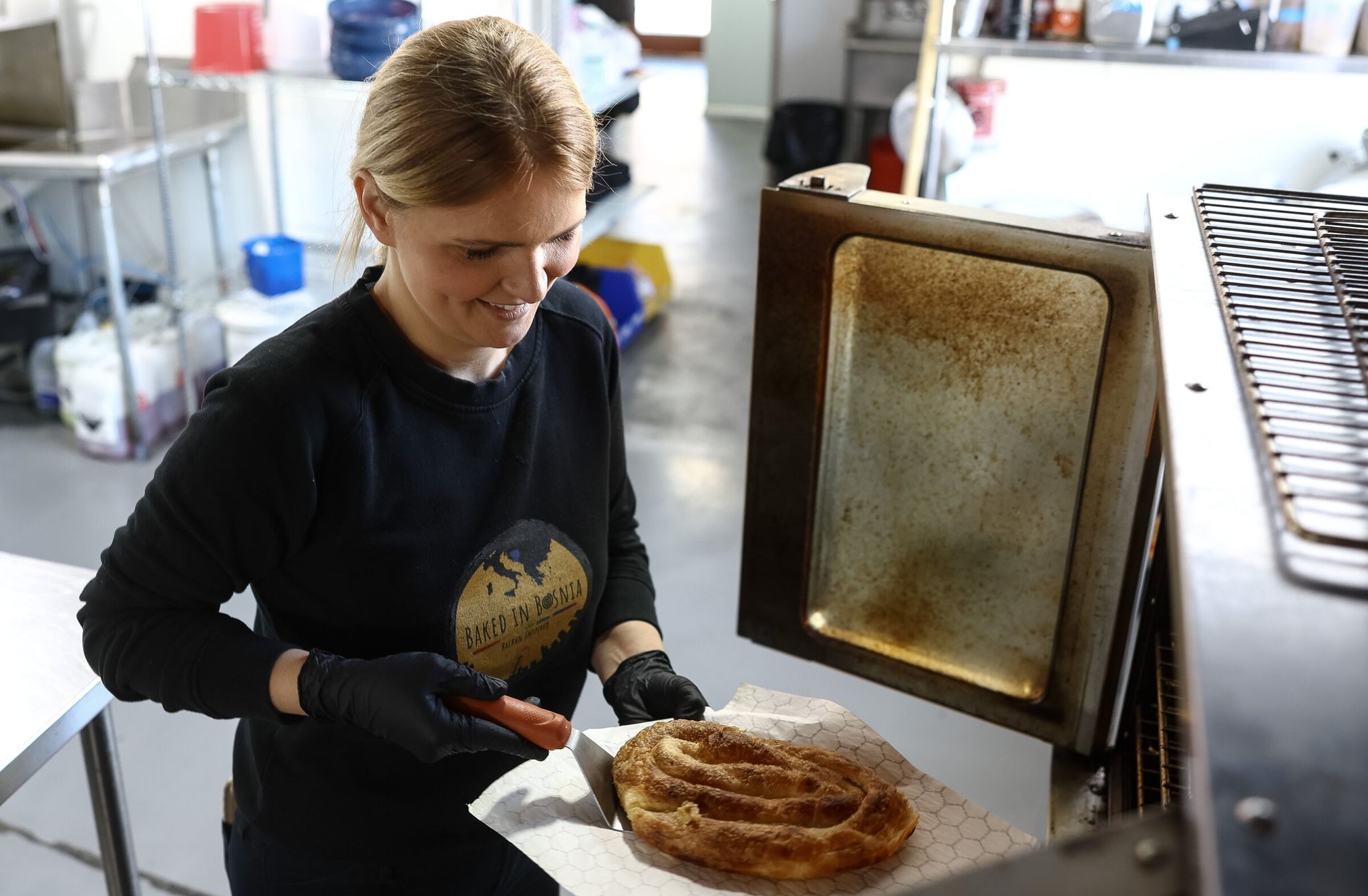 Selma Mänsell, shown last month at her Seattle business, is a co-owner of the catering company Baked in Bosnia. Her family and countless other members of the Bosnian diaspora in Seattle are looking forward with joy to the men’s national soccer team playing Qatar in Seattle during the 2026 World Cup. (Nick Wagner / The Seattle Times)