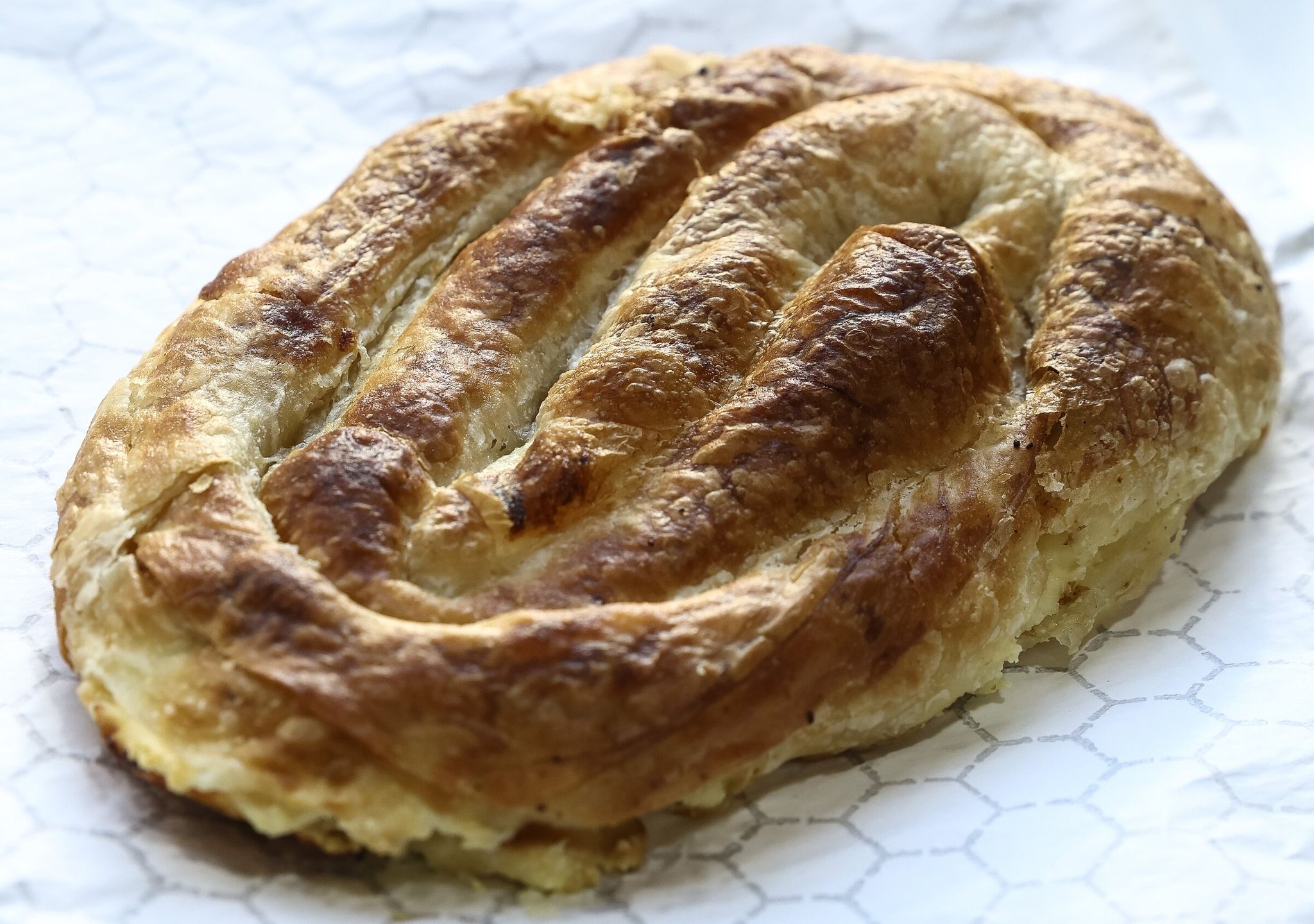 Baked in Bosnia makes Balkan-style savory pastries like this one and much more. (Nick Wagner / The Seattle Times)