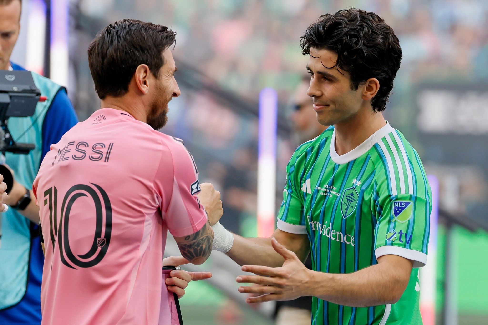 Inter Miami forward Lionel Messi claps hands with Seattle Sounders midfielder Paul Rothrock before the Leagues Cup final last August in Seattle. (Jennifer Buchanan / The Seattle Times)