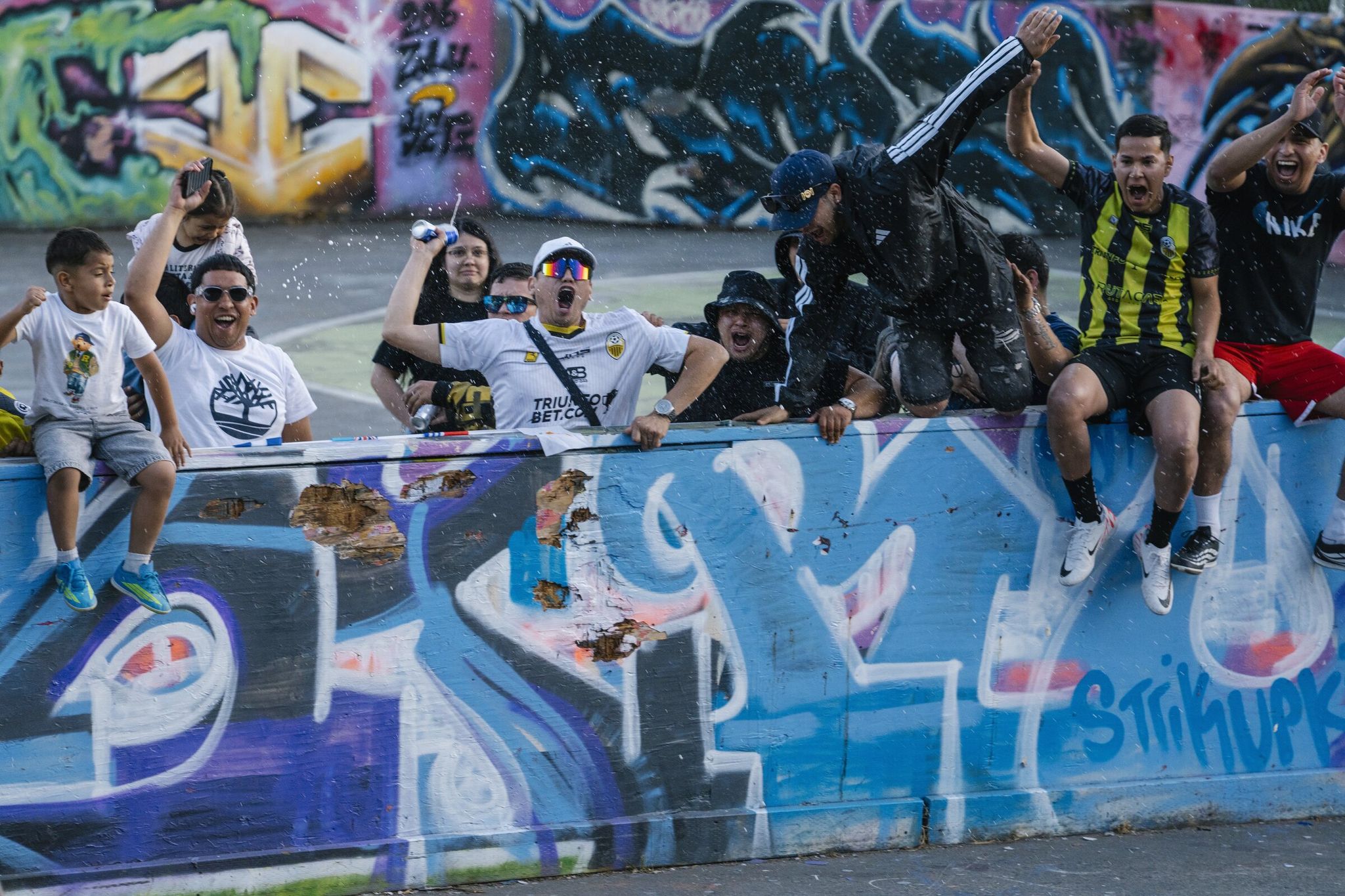 Spectators cheer as La Banda scores against Ivory Kings in the semifinal of the Les Kick’t 5v5 futsal tournament at the Judkins multifunctional field. La Banda won the match and finished second in the tournament. (M. Scott Brauer / Special to The Seattle Times)