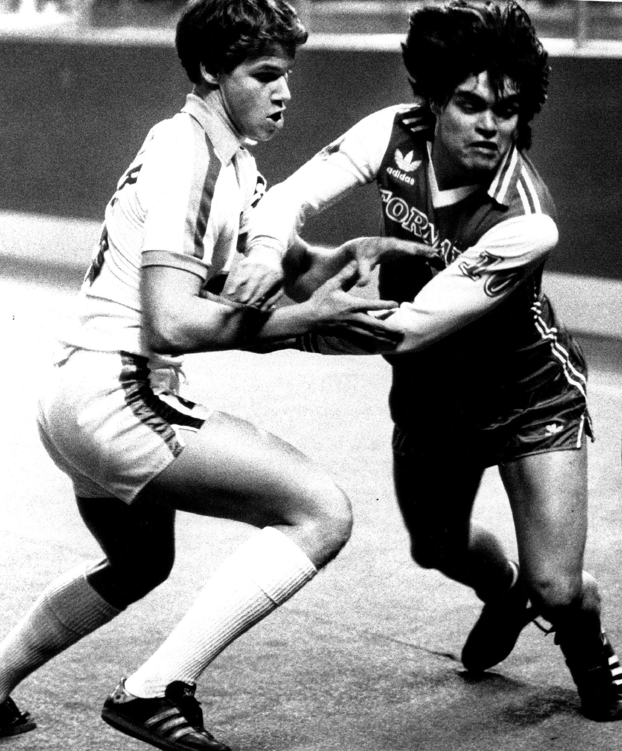 18-year-old Brian Schmetzer uses strength and footwork to battle Omar Gomez, the Argentine star of the Dallas Tornado, during a North American Soccer League match at the Kingdome. The Sounders won 8-4. (Bruce McKim / The Seattle Times, 1980)