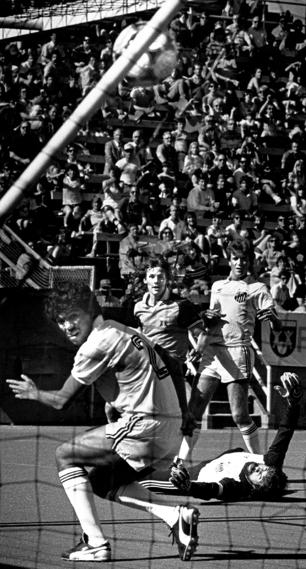 Brian Schmetzer, center, watches his winning goal hit the net. Schmetzer dribbled past an unidentified defender on the right, then shot over diving goalkeeper Rodolfo Rodriguez and past Davi Silva (2). (Paul Miller / The Seattle Times, 1985)