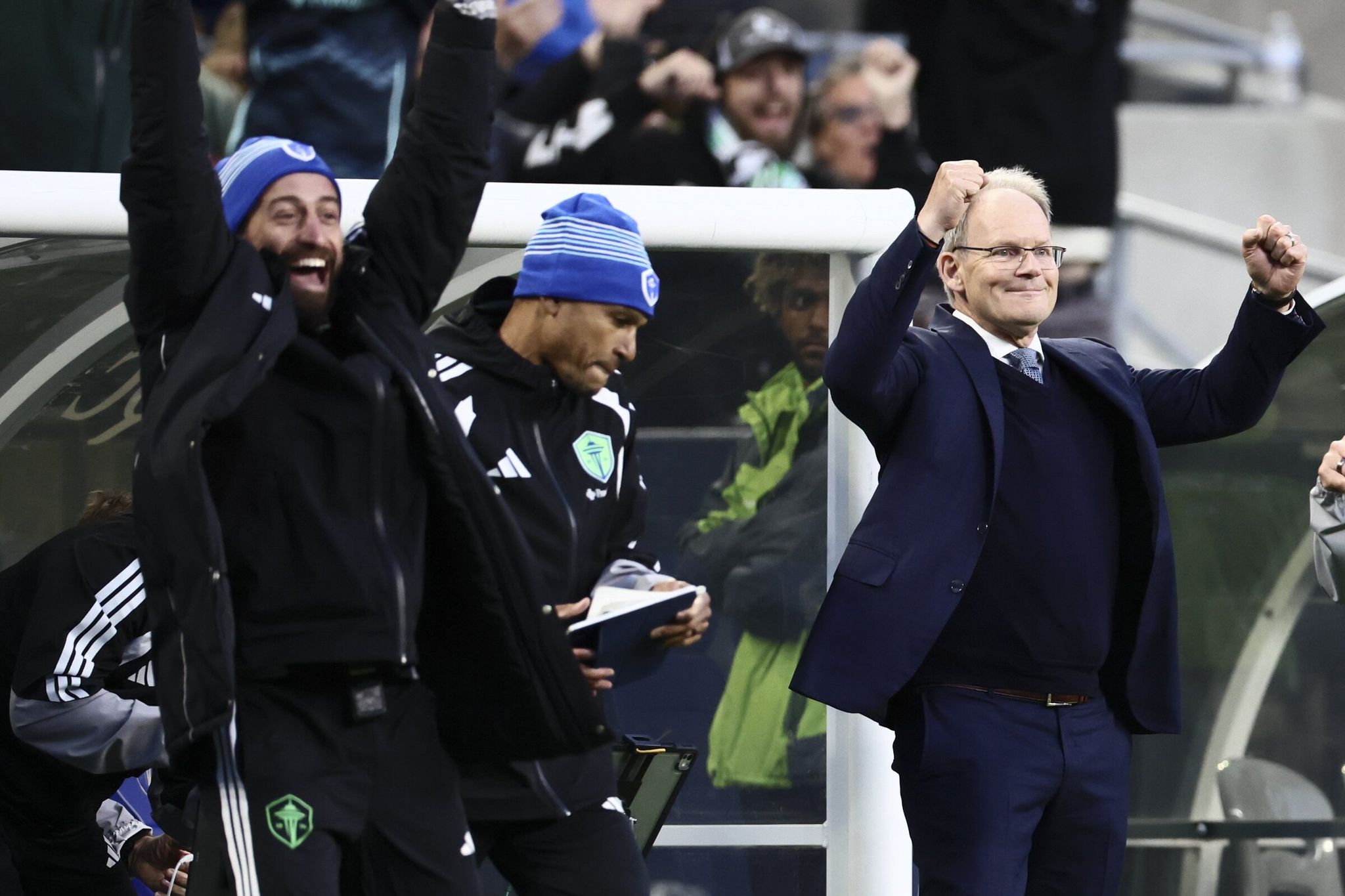 Adam Chentoufani (left) celebrates with Ricardo Clark and head coach Brian Schmetzer after a goal against the San Jose Earthquakes at Lumen Field in May. (Kevin Clark / The Seattle Times)