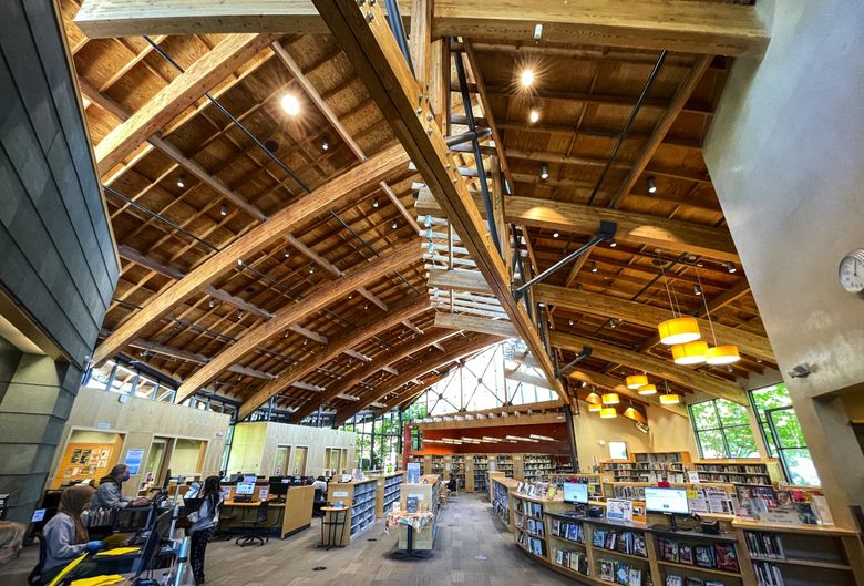 Located on the main drag, Seattle Library’s Beacon Hill branch, with its beautiful woodwork, acts almost as an unofficial community center for the neighborhood. (Ken Lambert / The Seattle Times)