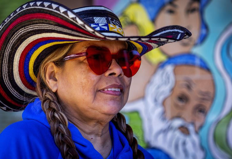 Angelina Castro wears her colorful sombrero vueltiao, a traditional hat from Castro’s native Colombia, while she waits in line to vote in the Colombian election at Plaza Maestas at El Centro de la Raza, in Seattle’s Beacon Hill neighborhood. (Ken Lambert / The Seattle Times)