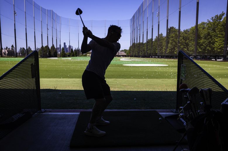 Trevor Milligan works on his golf swing at the Bill Wright Golf Complex at Jefferson Park, in Seattle’s Beacon Hill neighborhood. (Ken Lambert / The Seattle Times)