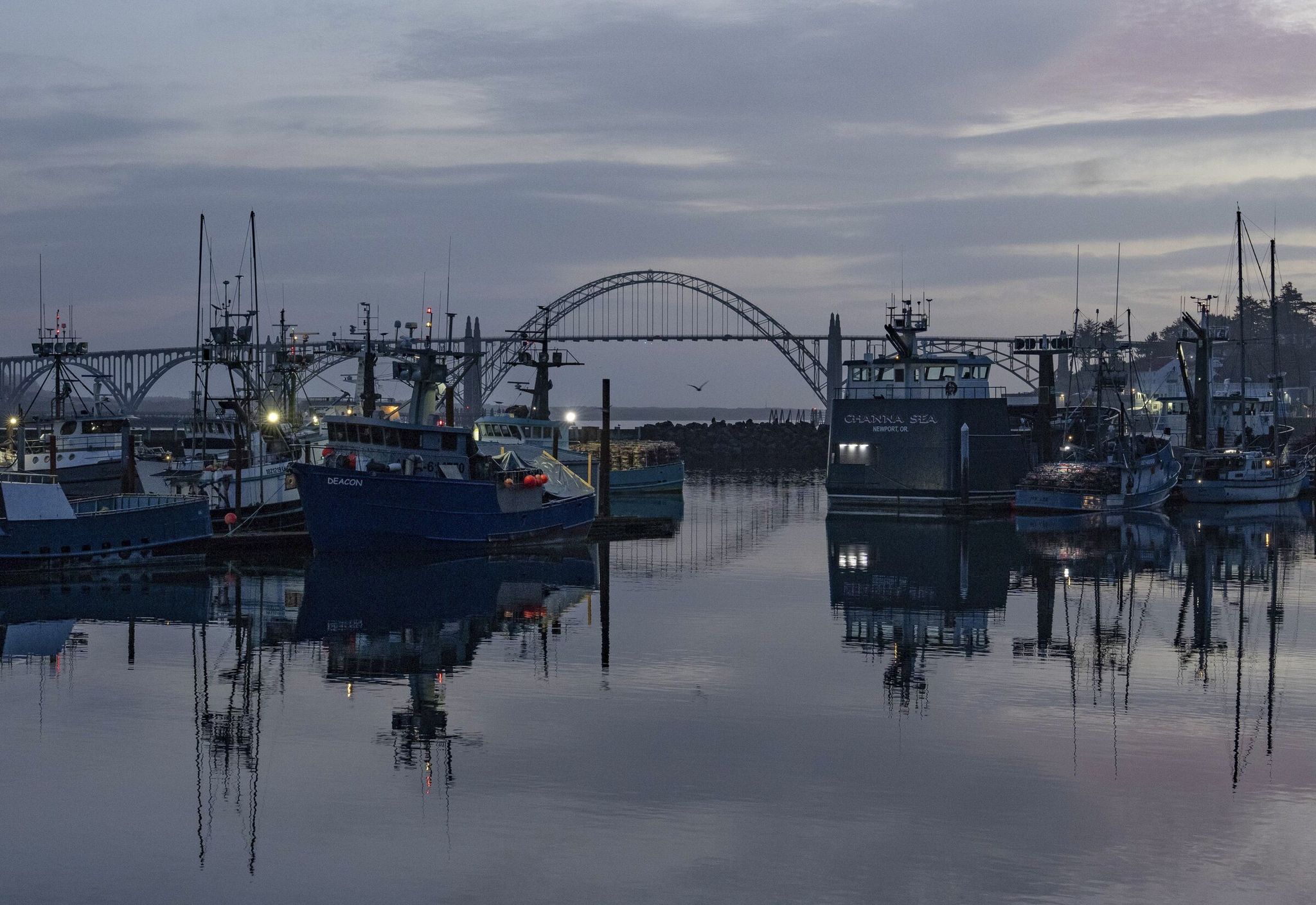 Fishing boats at the port in Newport, Ore. Nov. 23, 2025. Fishing and tourism are Newport’s economic pillars, and nearly every year-round resident knows someone who works on the water. (Ruth Fremson/The New York Times)