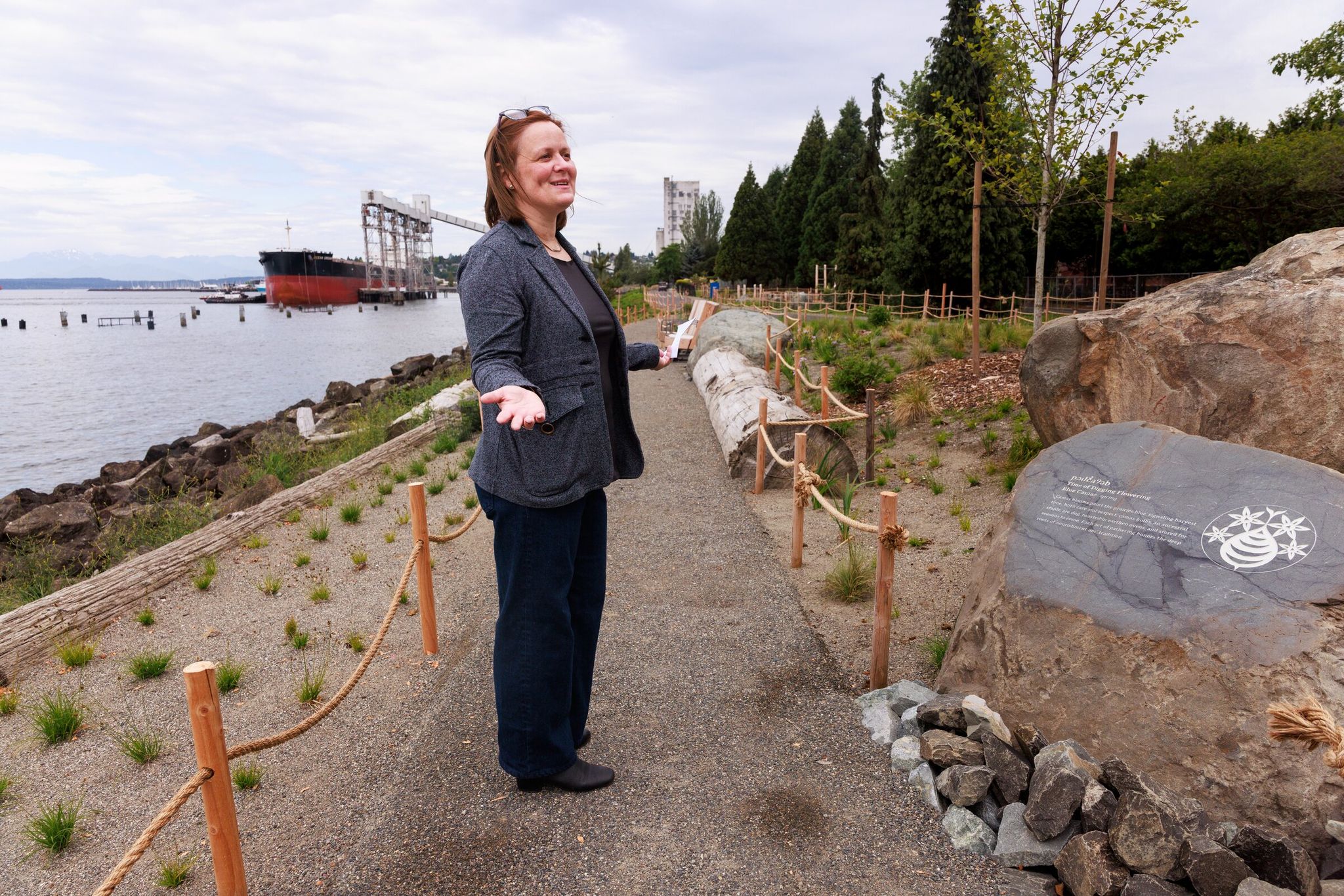 Lara Rose, principal at landscape architecture firm Walker Macy, gives a tour of the redesigned Myrtle Edwards and Centennial Parks in Seattle on Wednesday. (Erika Schultz / The Seattle Times)