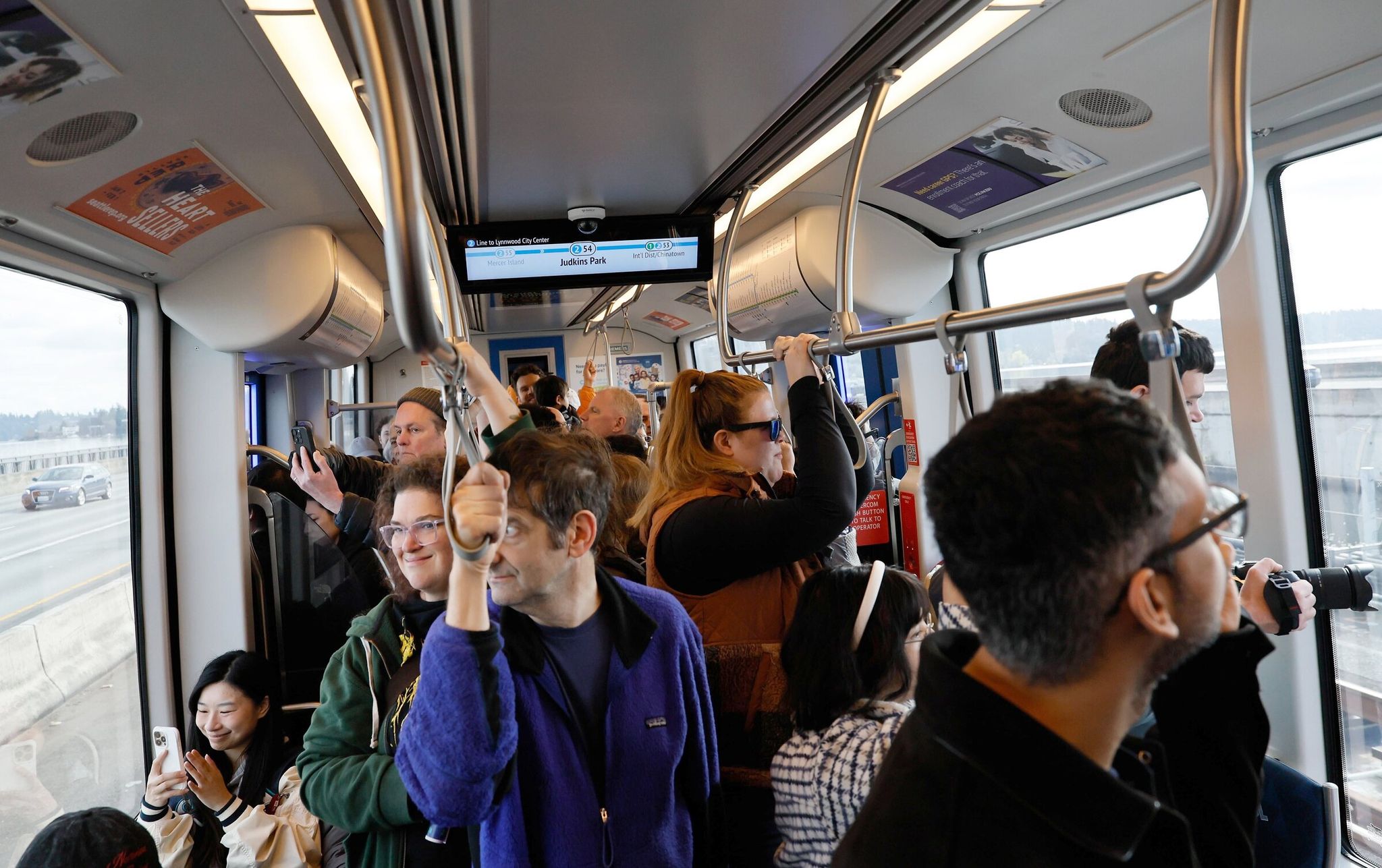 Passengers cross Lake Washington on the first day of Link light rail service to the Eastside. (Jennifer Buchanan / The Seattle Times)