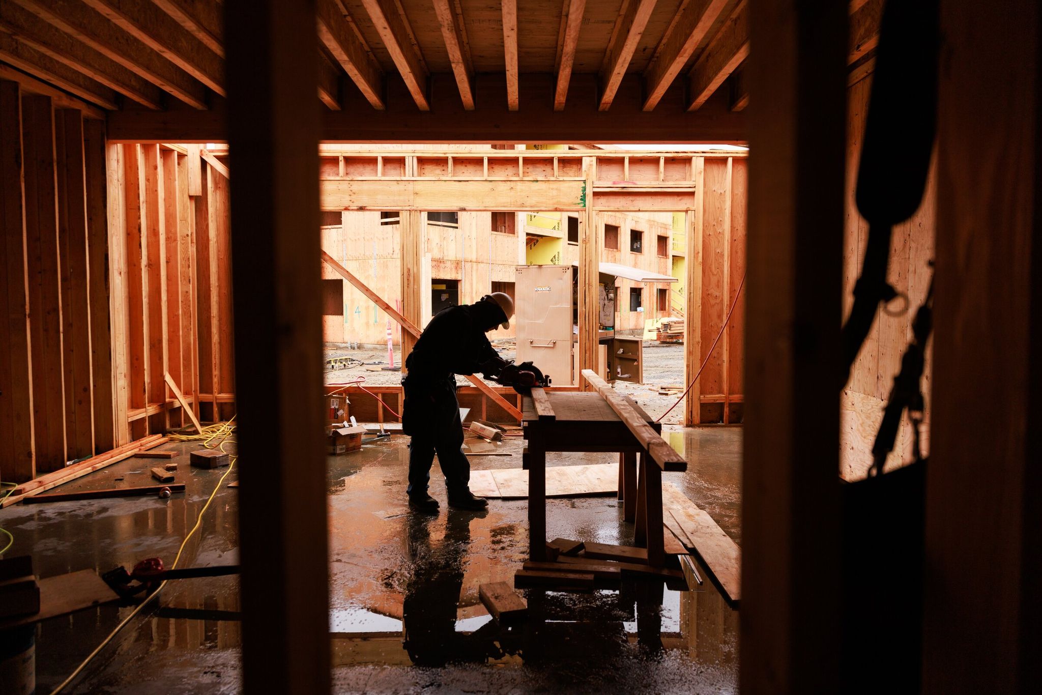 Construction workers, including apprentice carpenter Kaiden Williams, build housing for Edmonds School District students in Lynnwood on Thursday. This building was designed to house offices and public space. (Ericka Schultz / The Seattle Times)