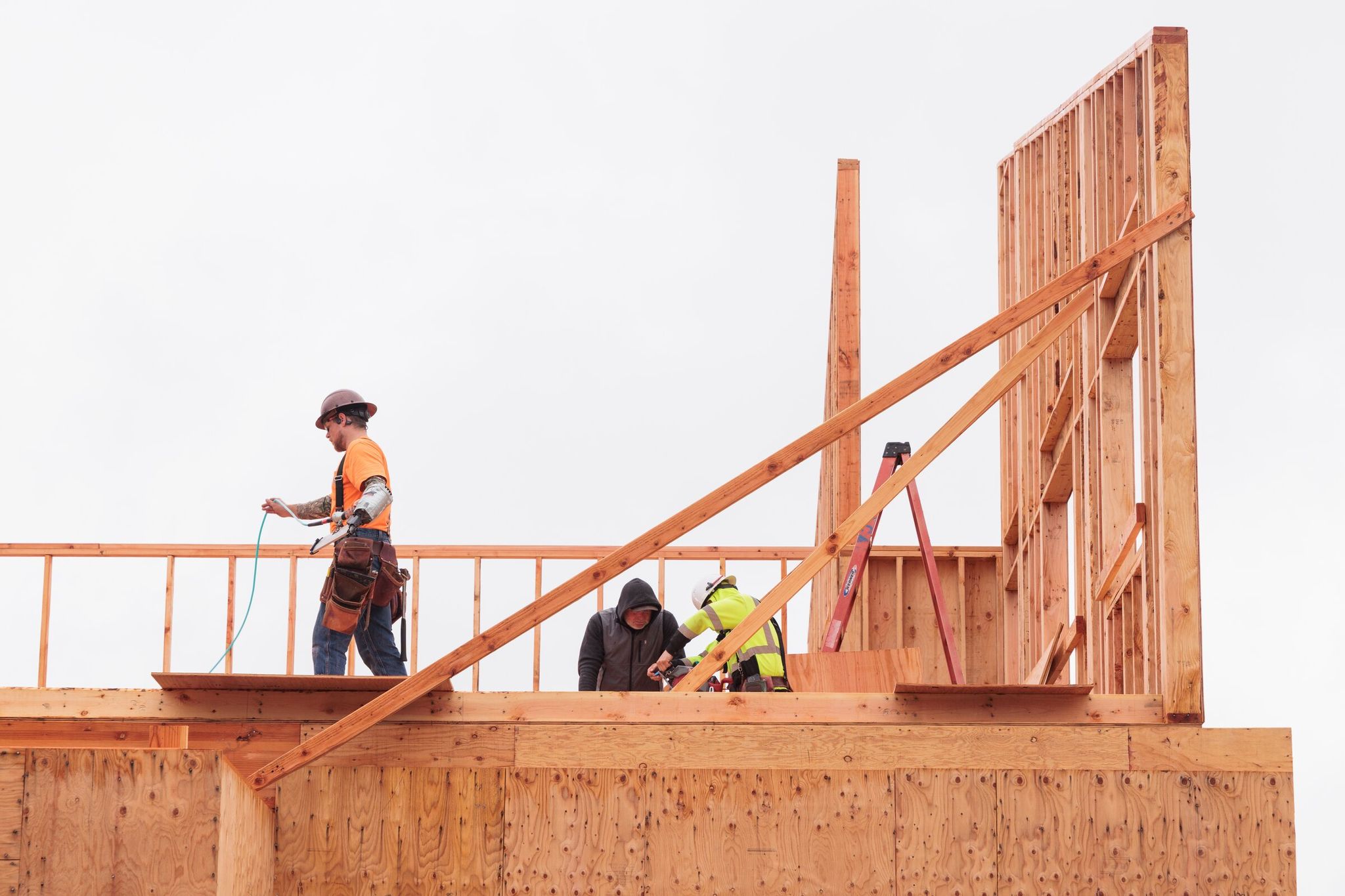 On Thursday in Lynnwood, construction workers work on public space and offices — part of a 52-unit affordable housing development built in partnership with the Edmonds School District to help homeless students. (Ericka Schultz / The Seattle Times)