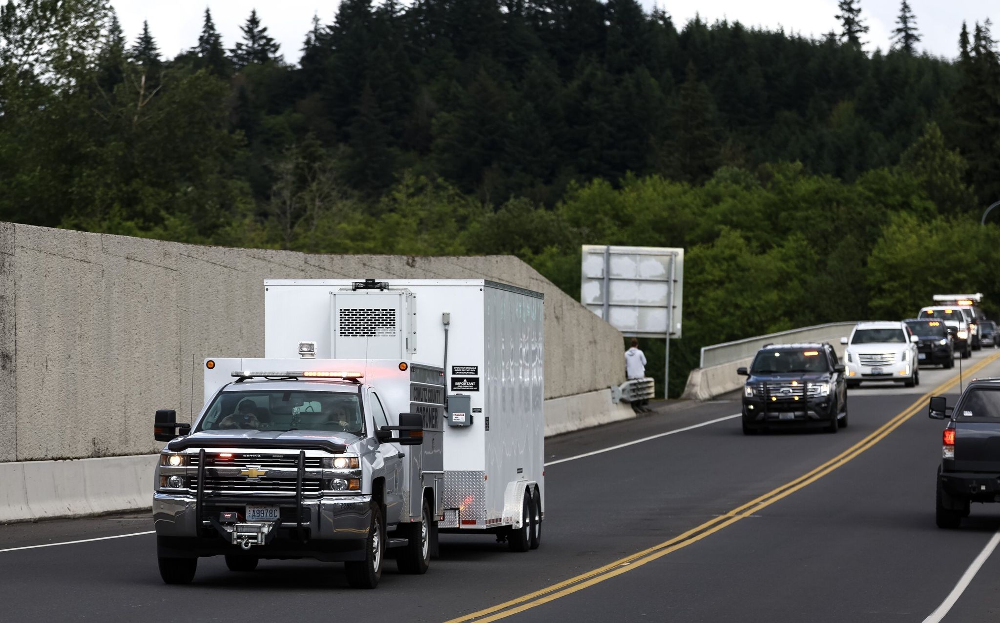 A Cowlitz County Coroner’s Office pickup and trailer transports nine of the 11 Nippon Dynawave victims back to Longview on Saturday. (Nick Wagner / The Seattle Times)