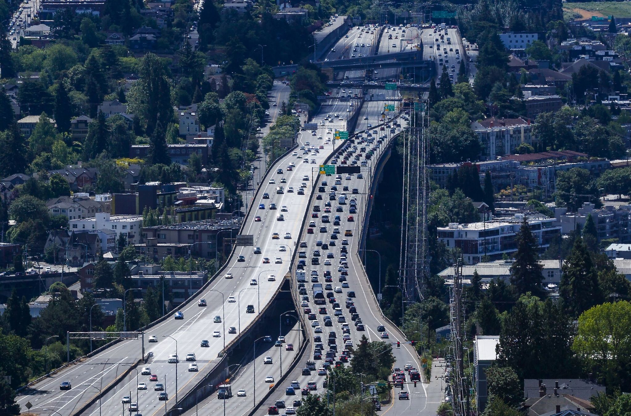 All northbound lanes of Interstate 5 over the Ship Canal Bridge, to the left, are now open Sunday in Seattle. The freeway will be fully open as six FIFA Men’s World Cup soccer matches get underway, with four northbound Ship Canal Bridge lanes instead of only the two that have been open lately. (Ken Lambert / The Seattle Times)